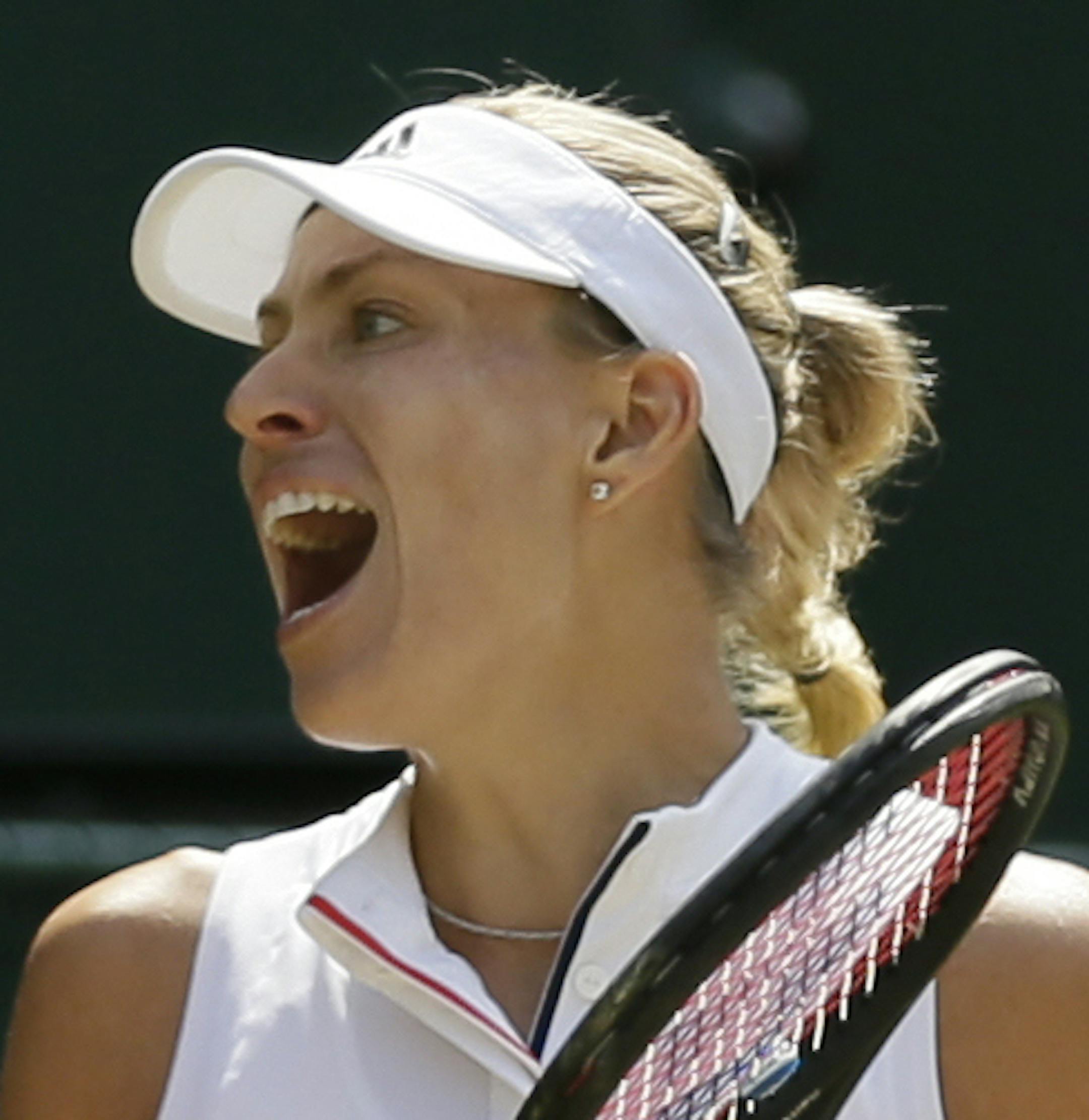 Germany's Angelique Kerber celebrates defeating Latvia's Jelena Ostapenko during their women's singles semifinals match at the Wimbledon Tennis Championships, in London, Thursday July 12, 2018.(AP Photo/Tim Ireland)