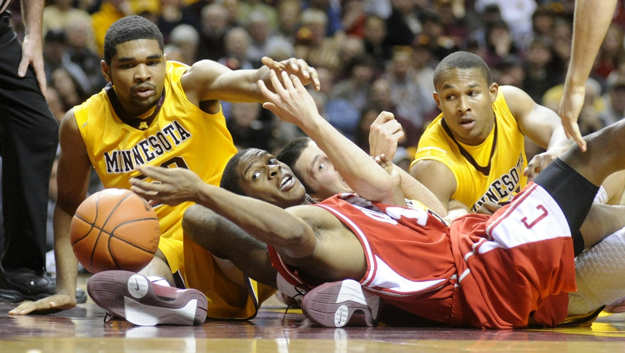 Minnesota's Ralph Sampson III, Blake Hoffarber , Lawrence Westbrook and Cornell's Louis Dale fight over a loose ball during the first half of an NCAA college men's basketball game in Minneapolis on Saturday.