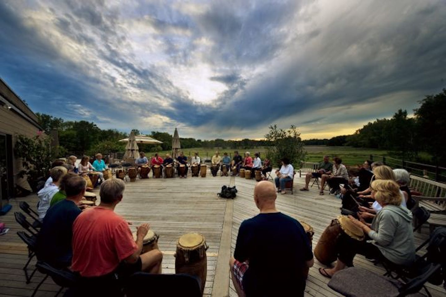 On a deck behind the main building at the Marsh, a "Meditation and Drumming" class taught by Marc Anderson took in a sunset as well as their rhythms.