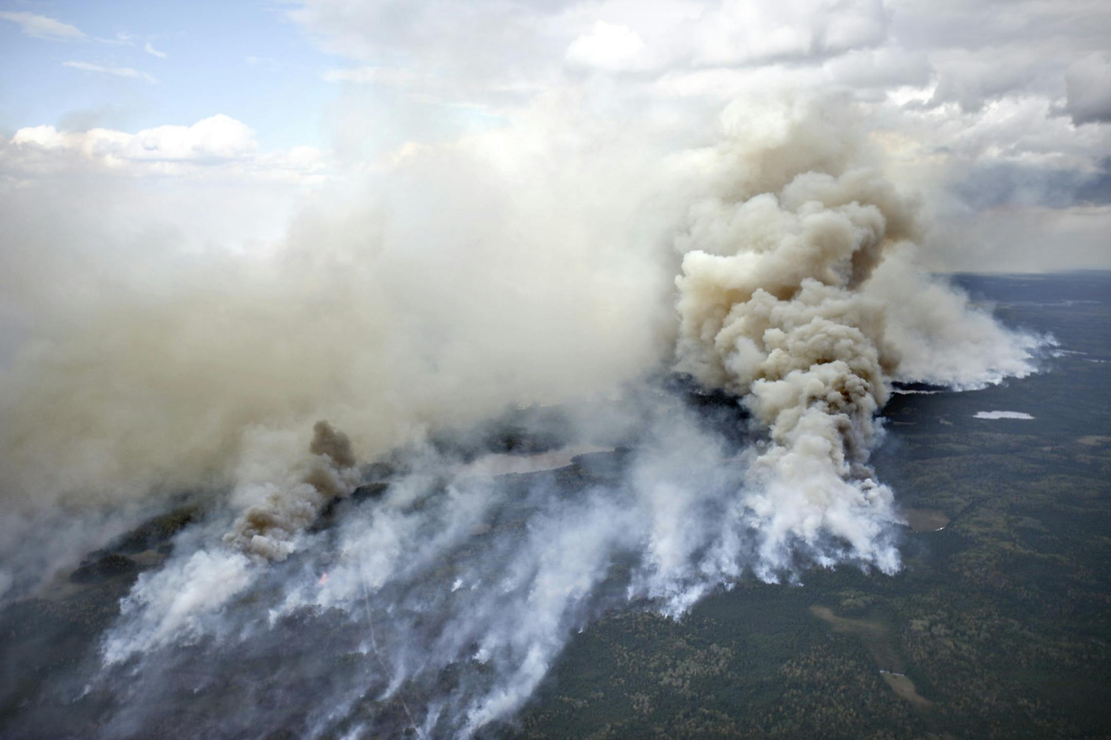 In this aerial photo, an area of the Pagami Creek wildfire shows active burning and creates a large smoke plume on Tuesday Sept. 13, 2011 in the Boundary Waters Canoe Area Wilderness in Northeastern Minnesota. The haze from the fire was heavy enough that some people reported burning eyes and difficulty breathing in the Chicago area, 400 miles south of the forest fire, the National Weather Service said.