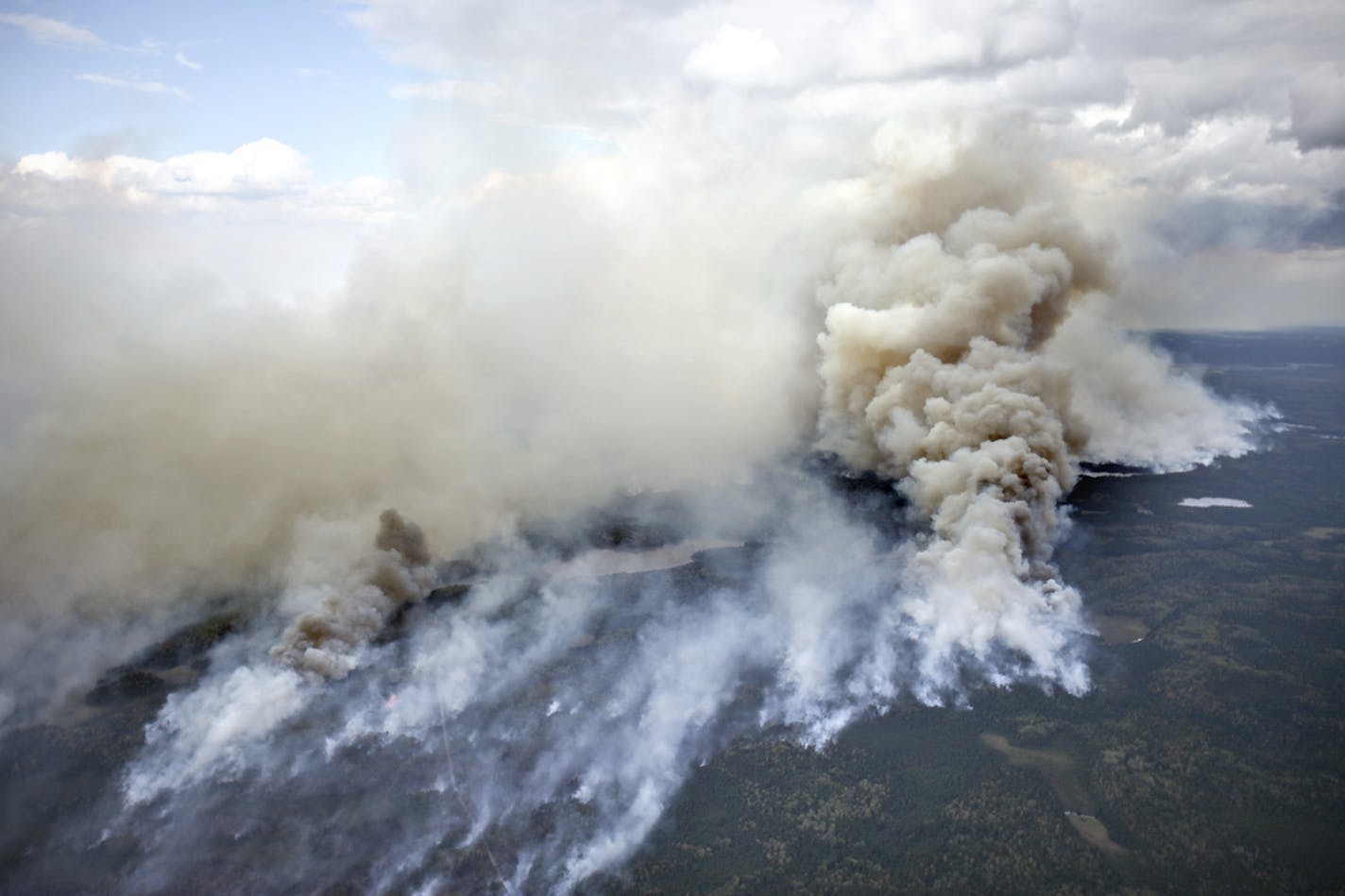 In this aerial photo, an area of the Pagami Creek wildfire shows active burning and creates a large smoke plume on Tuesday Sept. 13, 2011 in the Boundary Waters Canoe Area Wilderness in Northeastern Minnesota. The haze from the fire was heavy enough that some people reported burning eyes and difficulty breathing in the Chicago area, 400 miles south of the forest fire, the National Weather Service said.