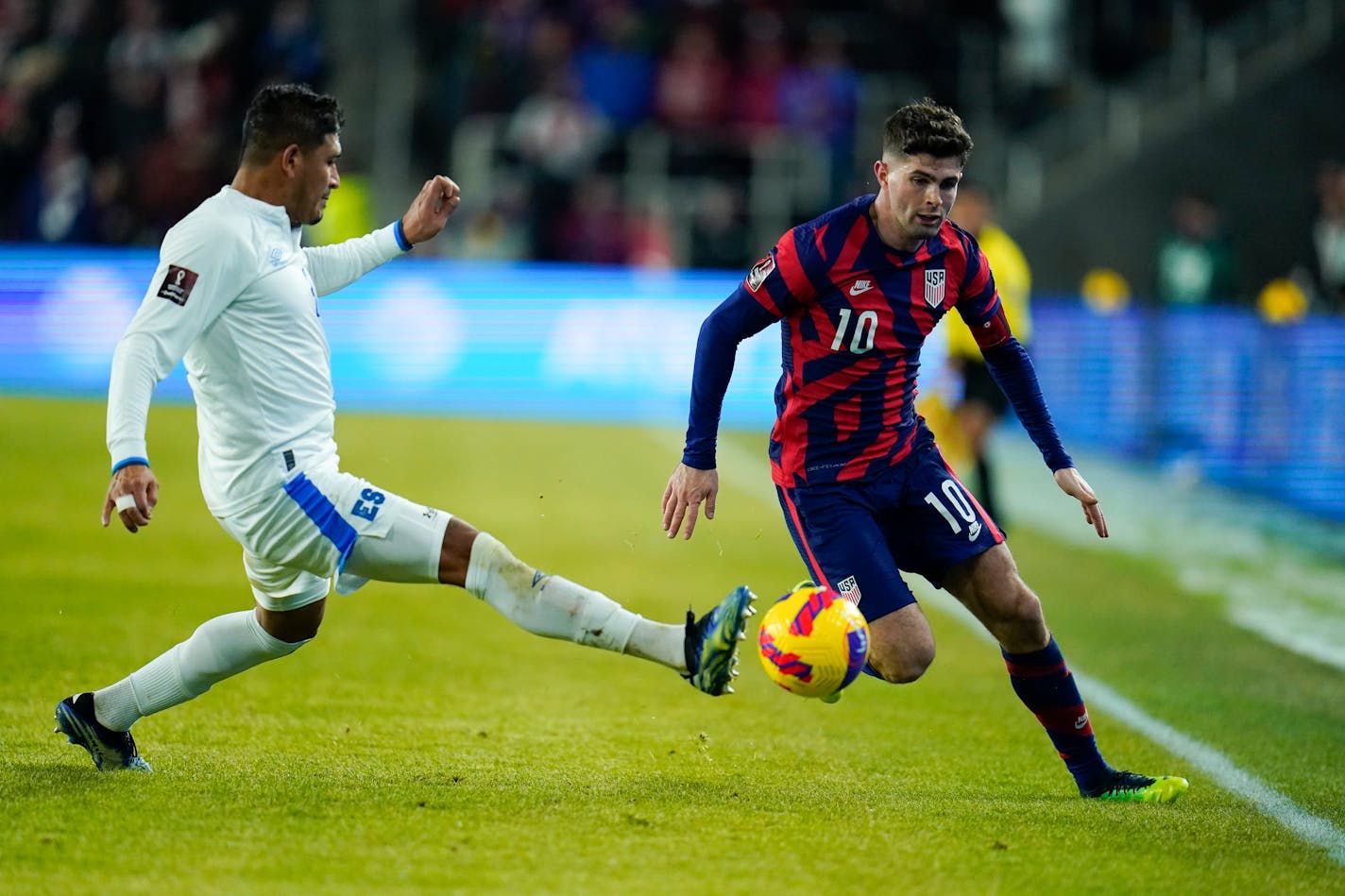 El Salvador's Roberto Dominguez, left, and United States' Christian Pulisic compete for possession during the first half of a FIFA World Cup qualifying soccer match, Thursday, Jan. 27, 2022, in Columbus, Ohio. The U.S. won 1-0. (AP Photo/Julio Cortez)