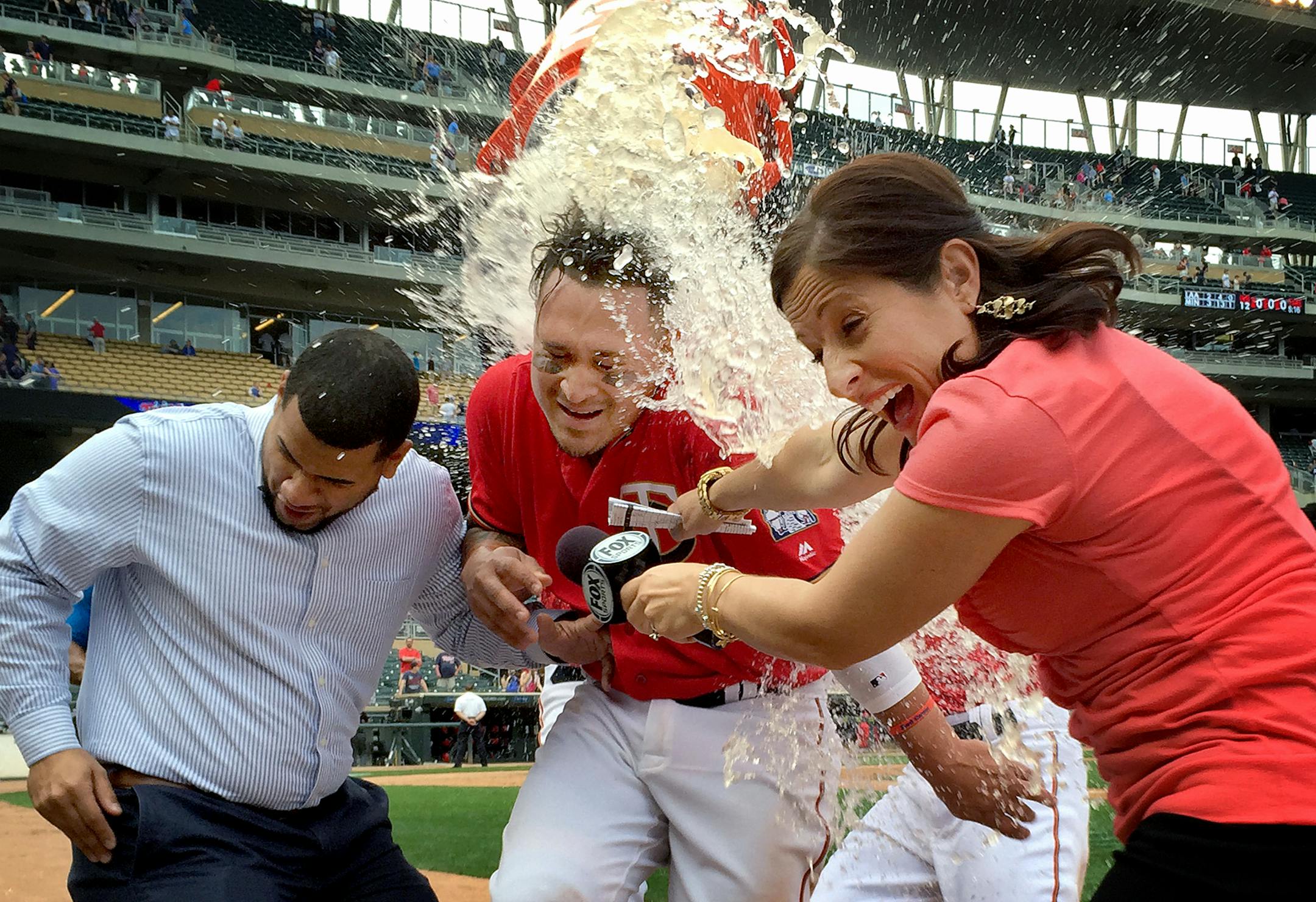 Oswaldo Arcia and his translator, along with Fox Sports North reporter Marney Gellner, were doused by the Twins' Miguel Sano and Eddie Rosario after Arcia drove in the winning run in a 3-2, 12-inning victory over the Los Angeles Angels on Sunday.