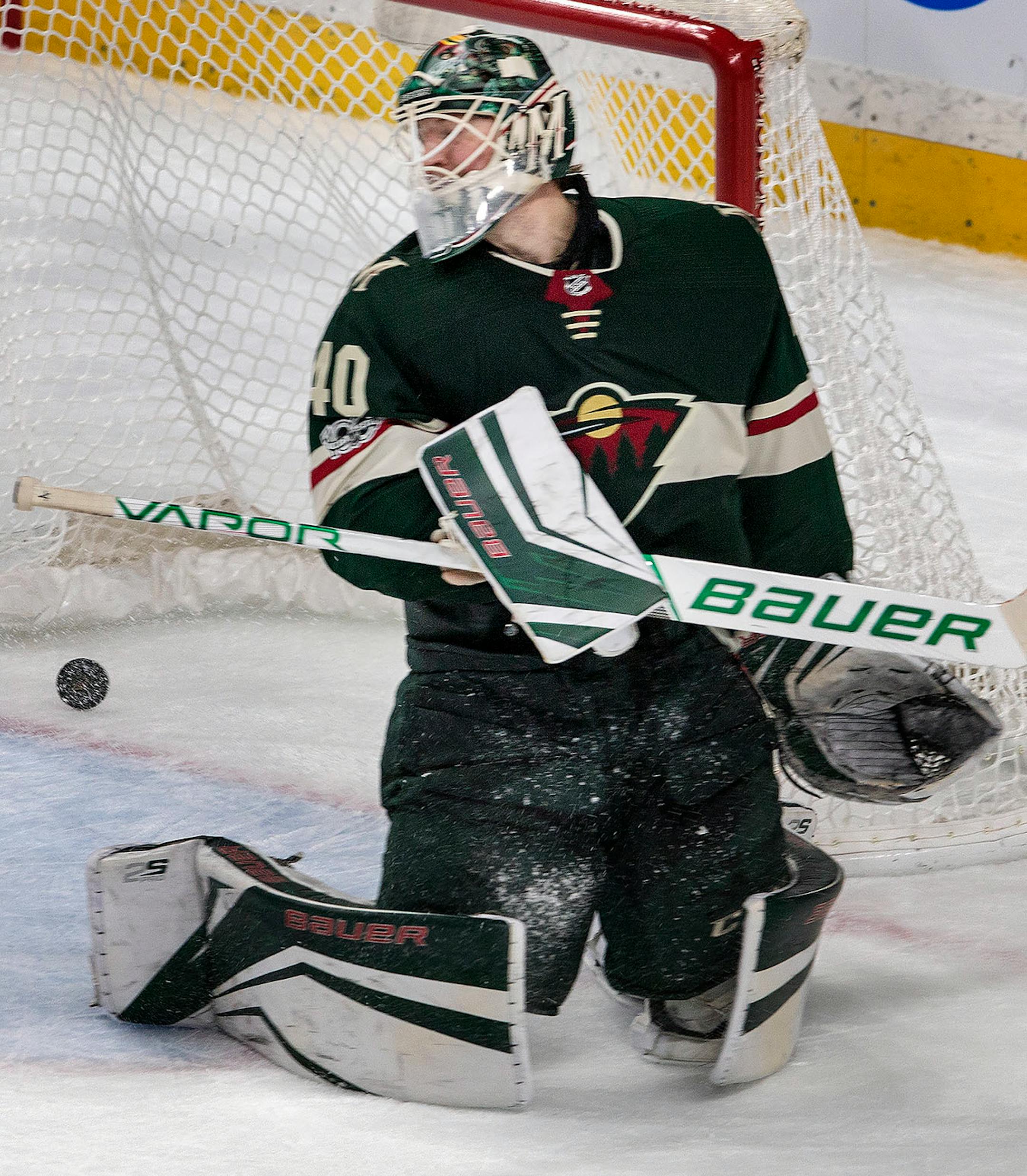 John Moore (2) shot the puck past Wild goalie Devan Dubnyk (40) to win the game in overtime.