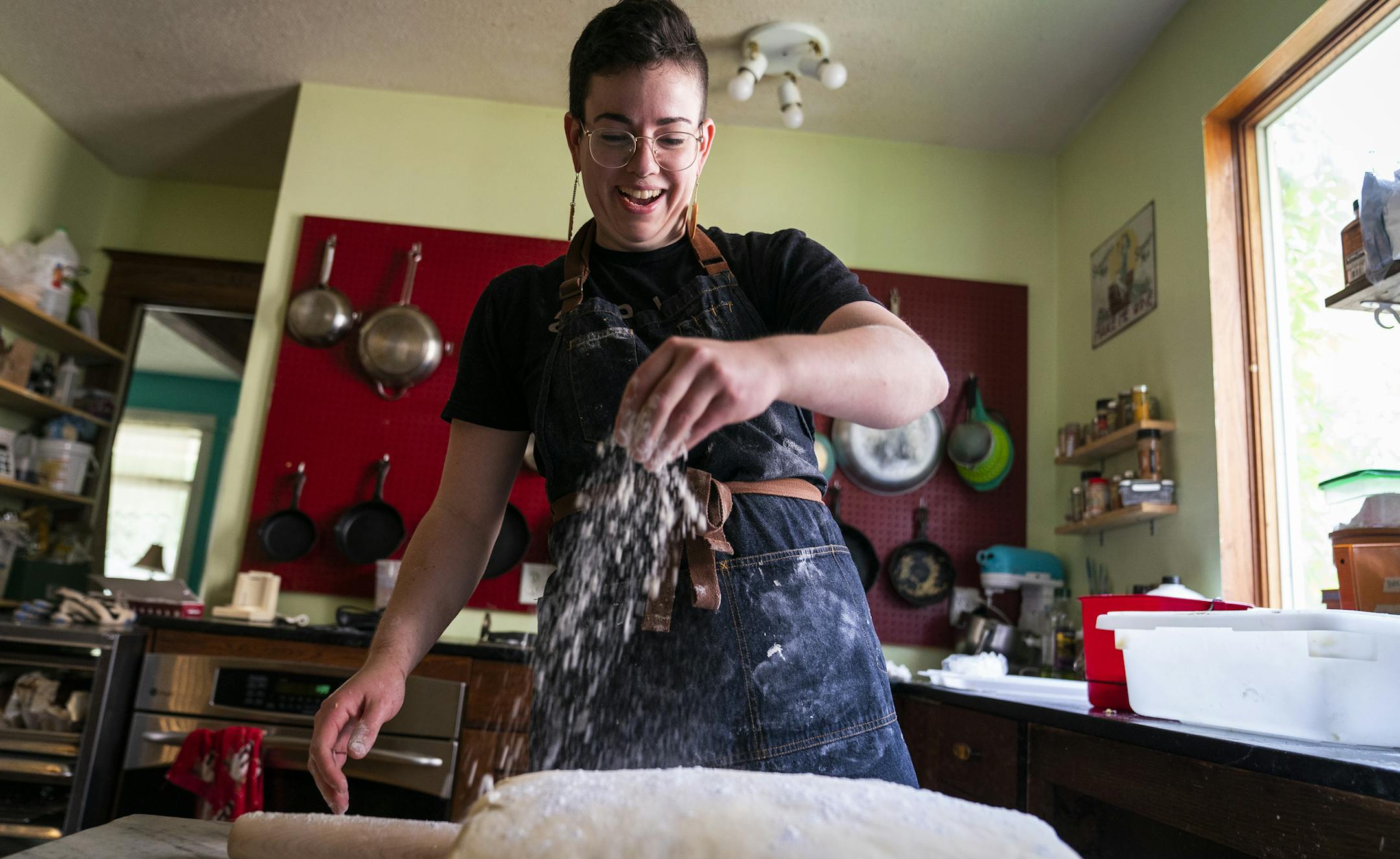 Abby Kastrul laminates brioche dough to make Bakery Box doughnuts. ] LEILA NAVIDI ¥ leila.navidi@startribune.com BACKGROUND INFORMATION: Abby Kastrul laminates dough to make Bakery Box doughnuts out of their home kitchen in Minneapolis on Friday, May 31, 2019. ***ABBY KASTRUL USES THEY/THEIR PRONOUNS***