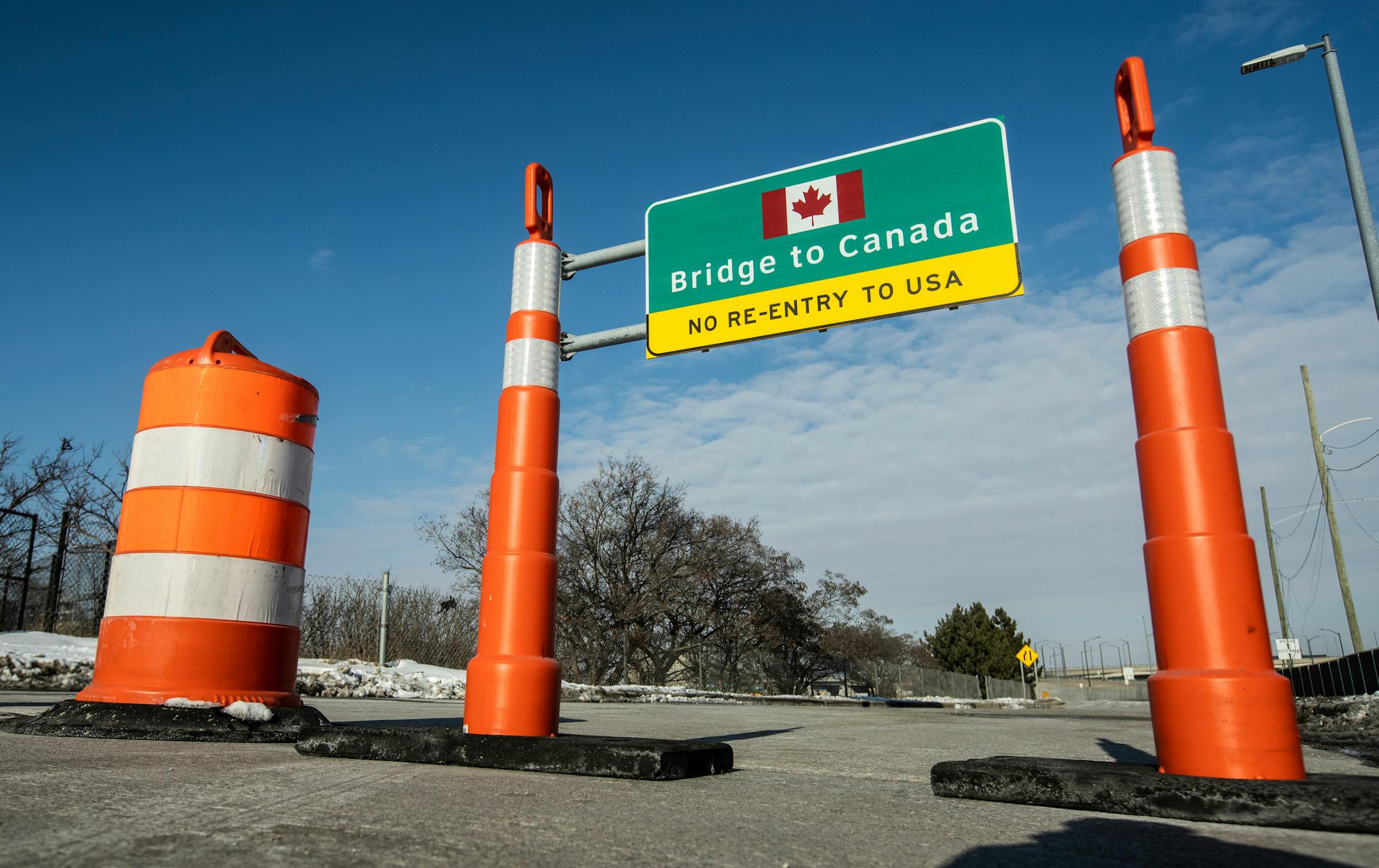 Cones block an entrance to the Ambassador Bridge entrance to Canada from Detroit on Tuesday, Feb. 8, 2022. Canadian lawmakers expressed increasing worry Tuesday about the economic effects of disruptive demonstrations after the busiest border crossing between the U.S. and Canada became partially blocked by truckers protesting vaccine mandates and other COVID-19 restrictions. (Ryan Garza/Detroit Free Press via AP)