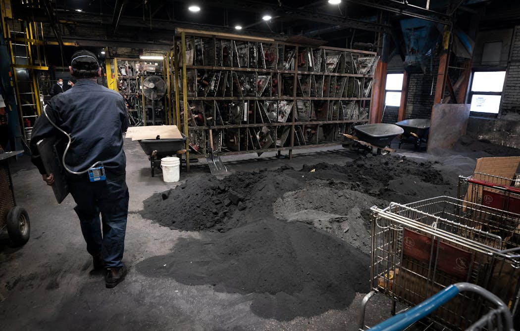 Piles of recovered black silica sand at Smith Foundry in 2023 in Minneapolis. 