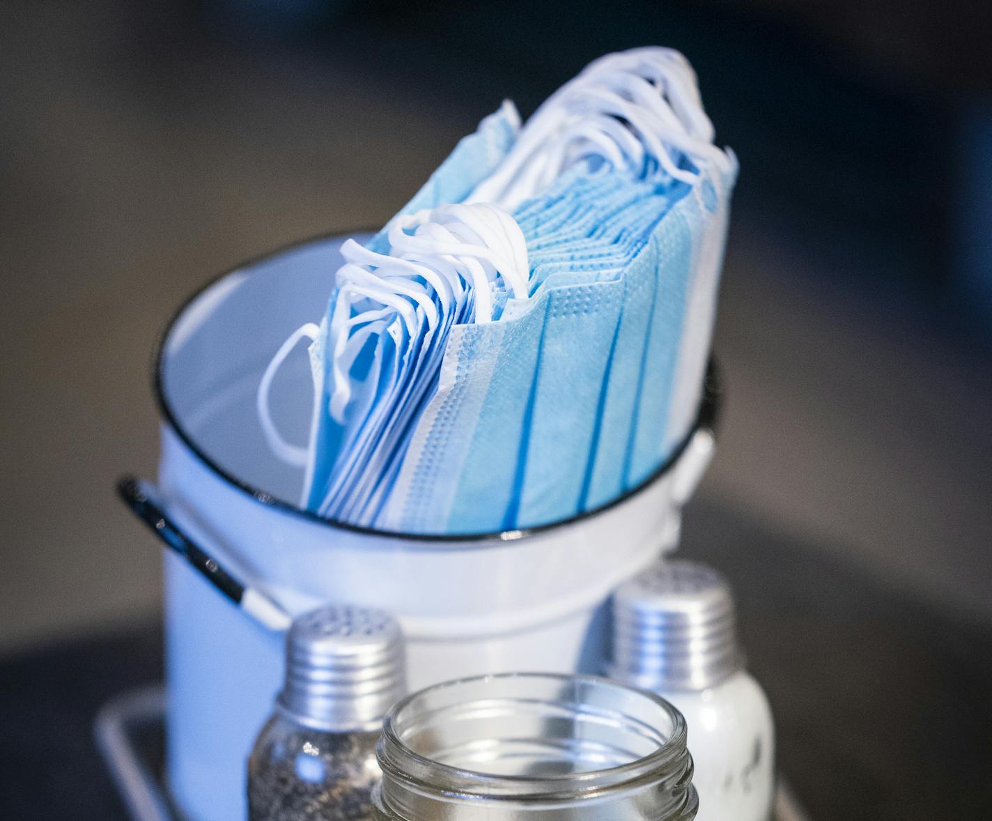 Face masks in a container at the Grocer's Table. ] LEILA NAVIDI • leila.navidi@startribune.com BACKGROUND INFORMATION: Owner Lindsay Pohlad and managers met with front end staff about the new COVID-19 protocols at the Grocer's Table in Wayzata on Tuesday, November 10, 2020. The Grocer's Table closed for two days to reconfigure the space to remove high-congestion areas, and to take indoor dining capacity down to 25%.