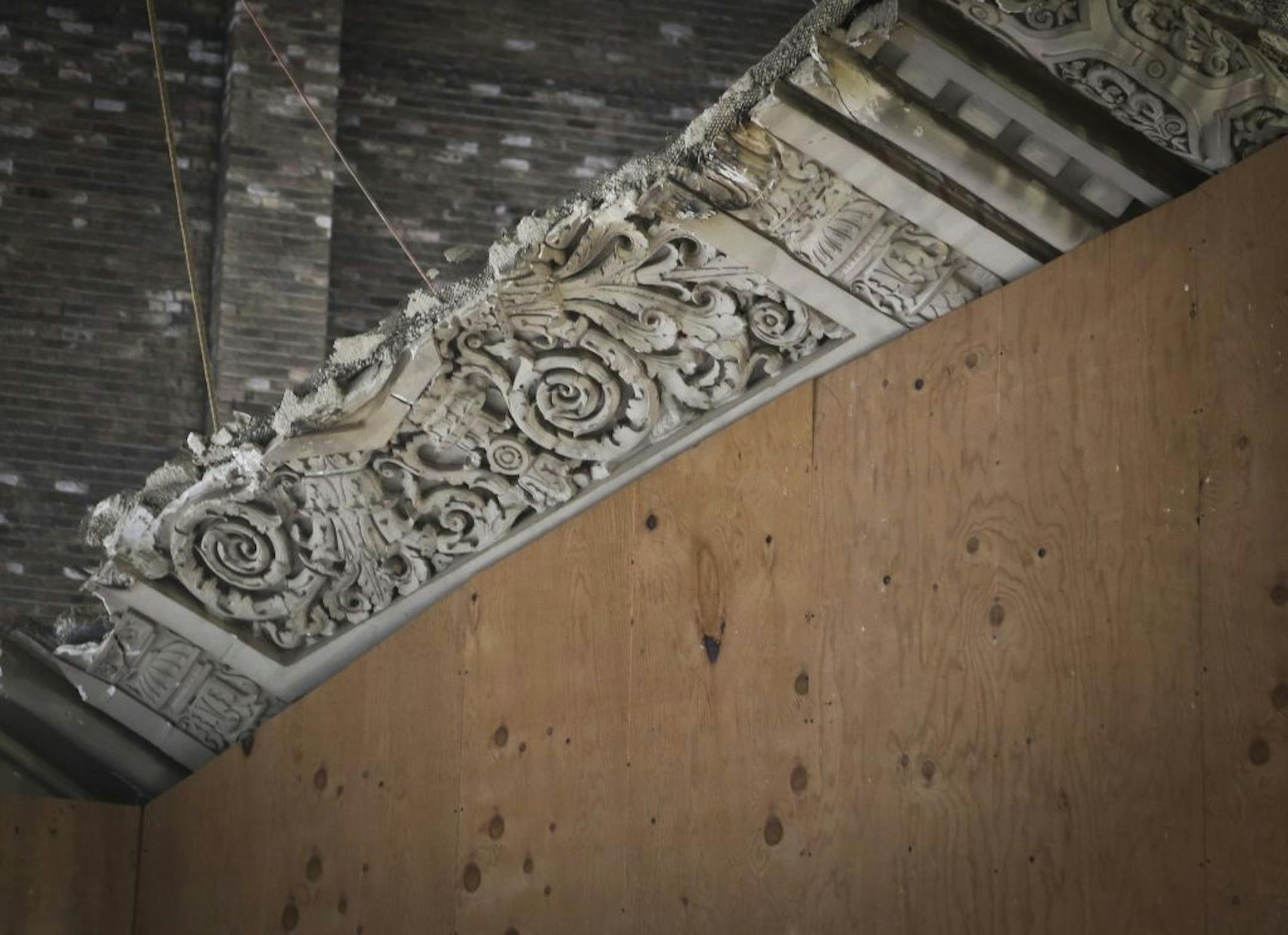 Contractors are preserving some of the rich detail of the building, including this arch. The rest of it is behind the plywood.