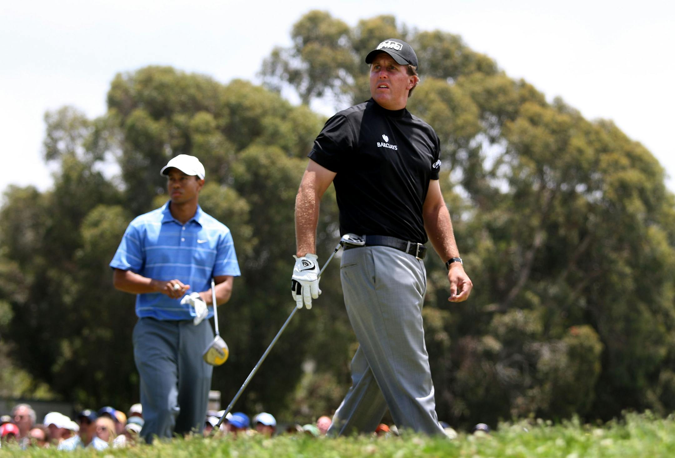 Phil Mickelson watches his tee shot on the 18th hole as Tiger Woods looks on during the first round of the 108th U.S. Open at the Torrey Pines Golf Course (South Course) on June 12, 2008 in San Diego, California.