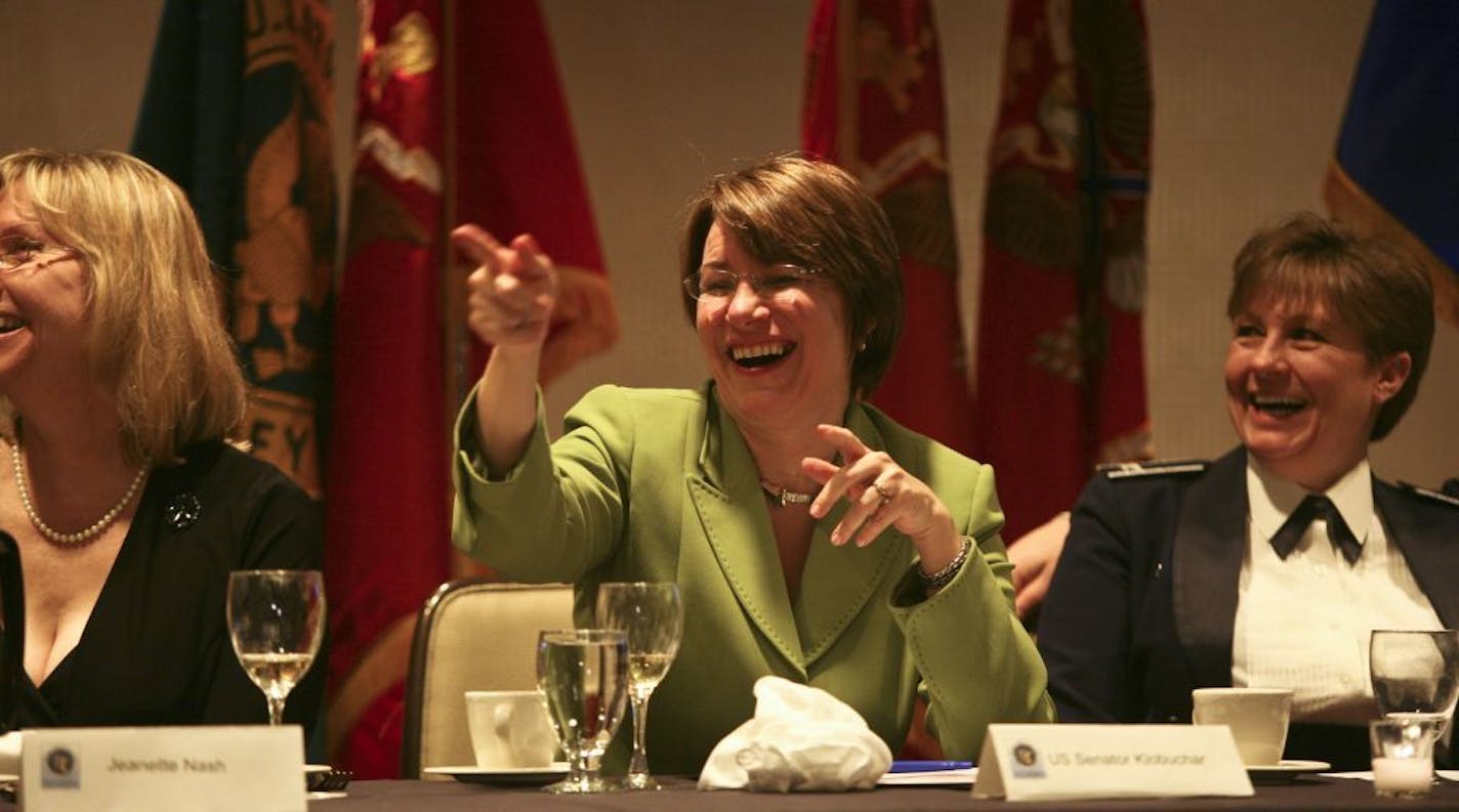 Sen. Amy Klobuchar joked around at the head table before her speech at a National Guard Association of Minnesota dinner in Rochester last month.