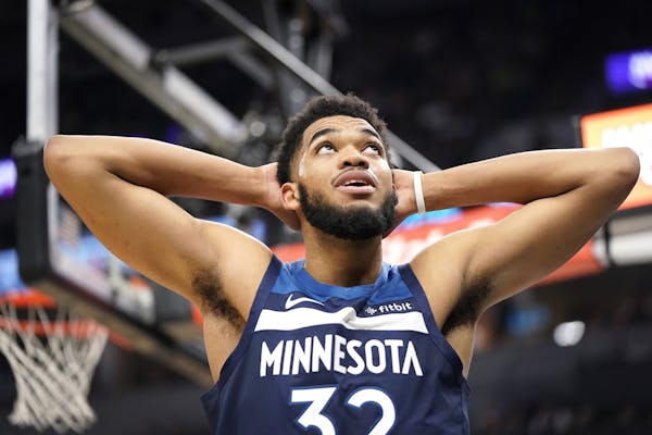 Minnesota Timberwolves center Karl-Anthony Towns (32) reacts to being called on a foul during overtime.