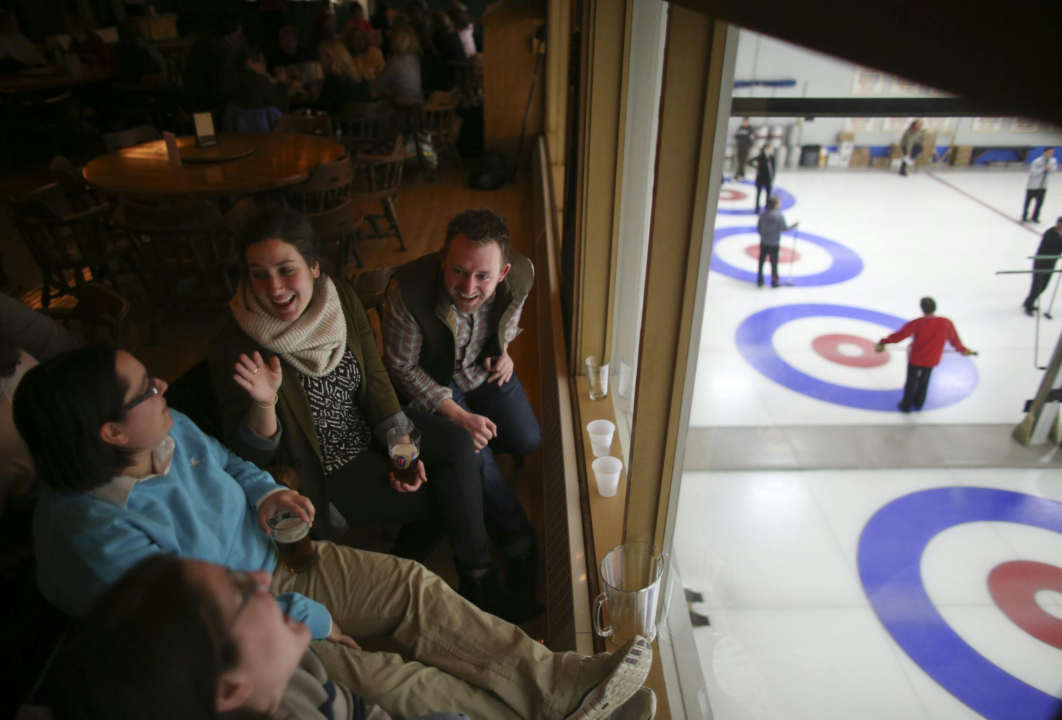 Curling fans, foreground to back, Andrea Craig, Robyn Jacobs, Kitty Hallau and Joe Craddock, watched games from the bar at the St. Paul Curling Club.