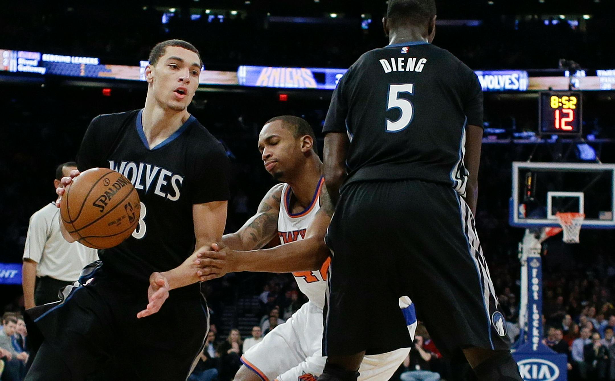 Minnesota Timberwolves' Zach LaVine (8) uses a pick set by teammate Gorgui Dieng (5) as New York Knicks' Lance Thomas (42) chases him during the first half of an NBA basketball game Thursday, March 19, 2015, in New York. (AP Photo/Frank Franklin II)