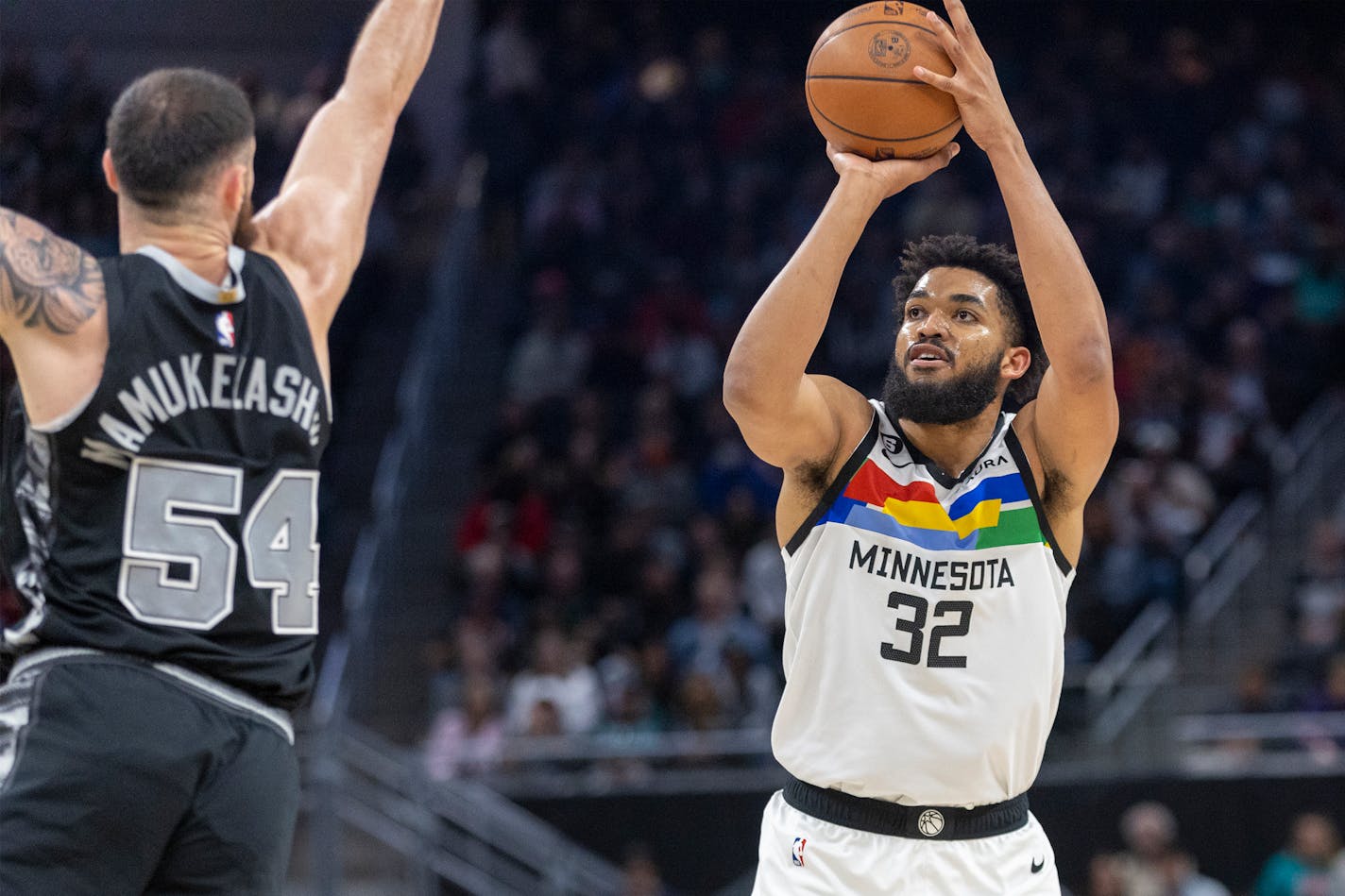 Minnesota Timberwolves center Karl-Anthony Towns (32) shoots over San Antonio Spurs forward Sandro Mamukelashvili (54) during the first half of an NBA basketball game, Saturday, April 8, 2023, in Austin, Texas. (AP Photo/Stephen Spillman)