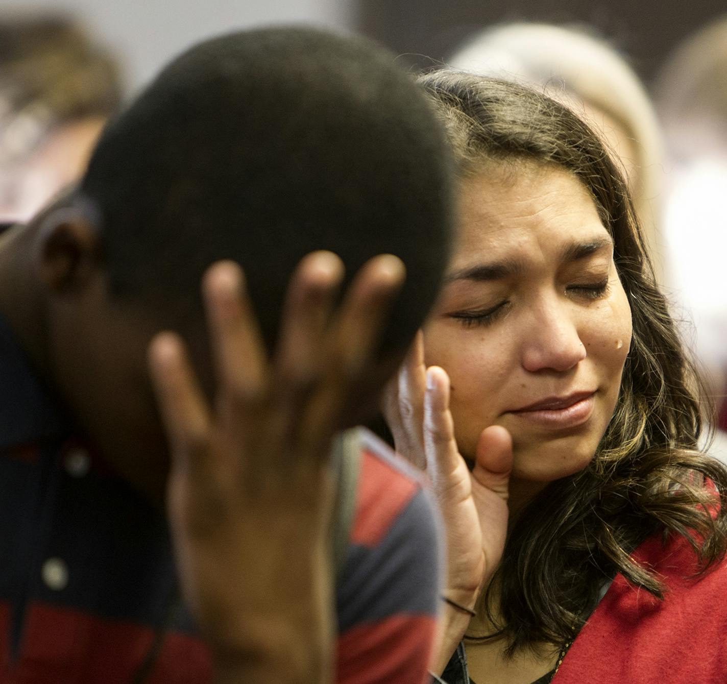 Mary Delorie and others wiped away tears during a prayer led by Clyde Bellecourt before the Minneapolis City Council unanimously voted to call what has been known as Columbus Day "Indigenous People's Day" April 25, 2014. (Courtney Perry/Special to the Tribune)