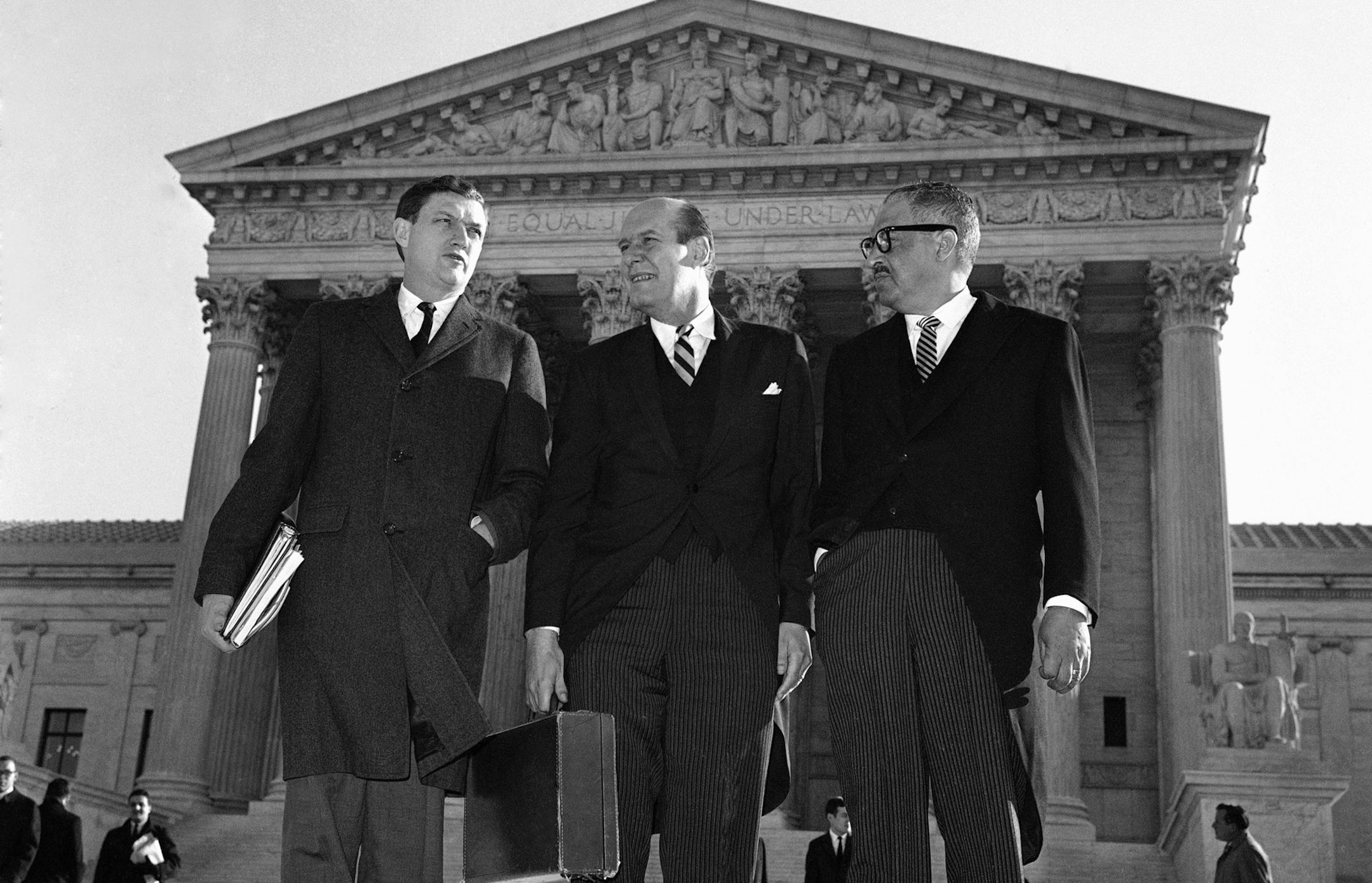 FILE - In this Jan. 17, 1966 file photo, Attorney General Nicholas Katzenbach, center, stands with Solicitor General Thurgood Marshall, left, and Assistant Attorney General John Doar as they arrive at the Supreme Court Building in Washington to defend the legality of the 1965 Voting Rights Act. Doar, who as a top Justice Department civil rights lawyer in the 1960s fought to protect the rights of black voters and integrate universities in the South, died Tuesday at age 92. (AP Photo)