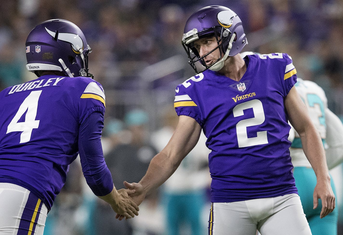 Ryan Quigley (4) congratulated kicker Kai Forbath (2) after a successful field goal