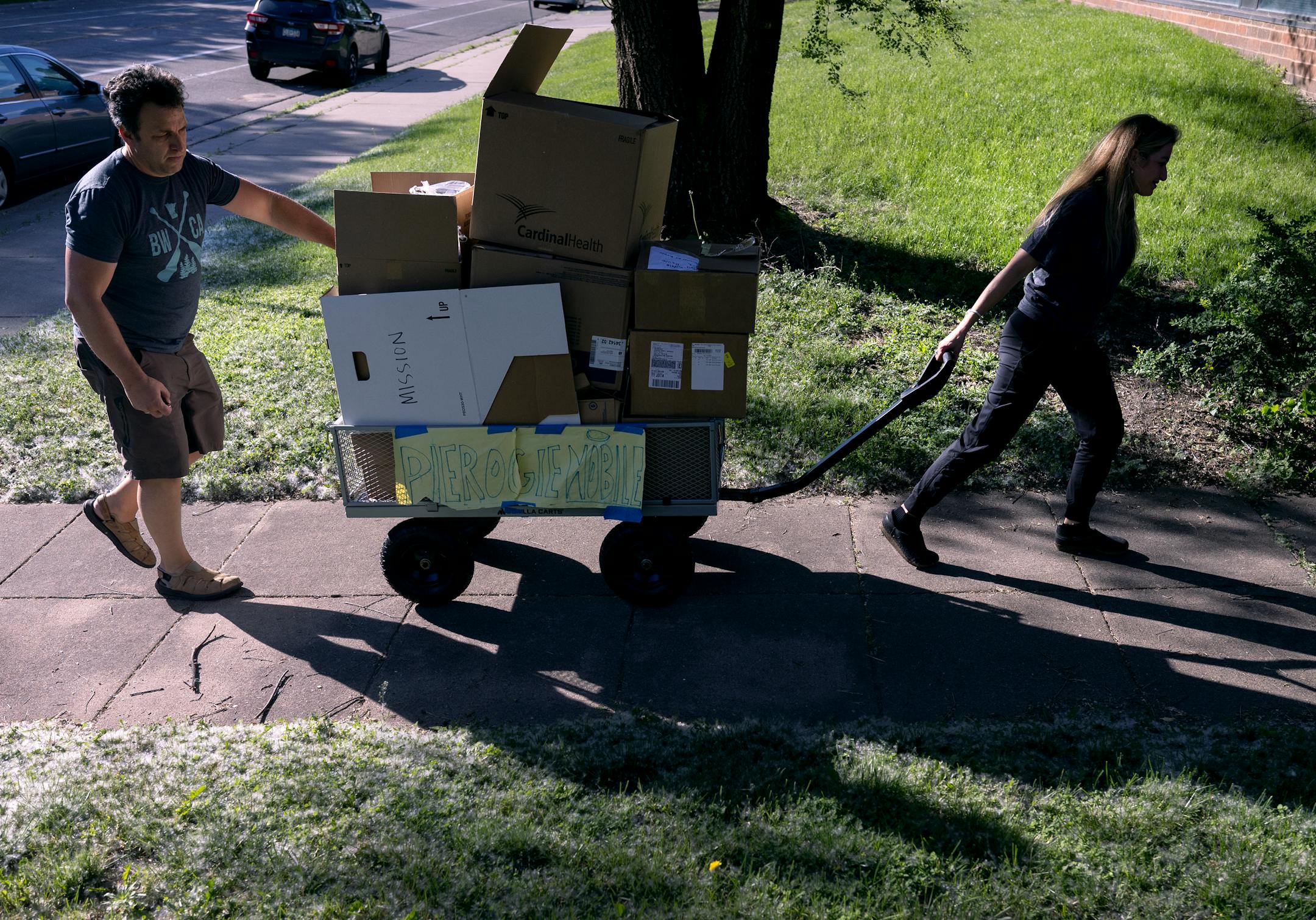 Mykola Sarazhynskyy and Sasha Sakurets moved a cart of medical supplies.