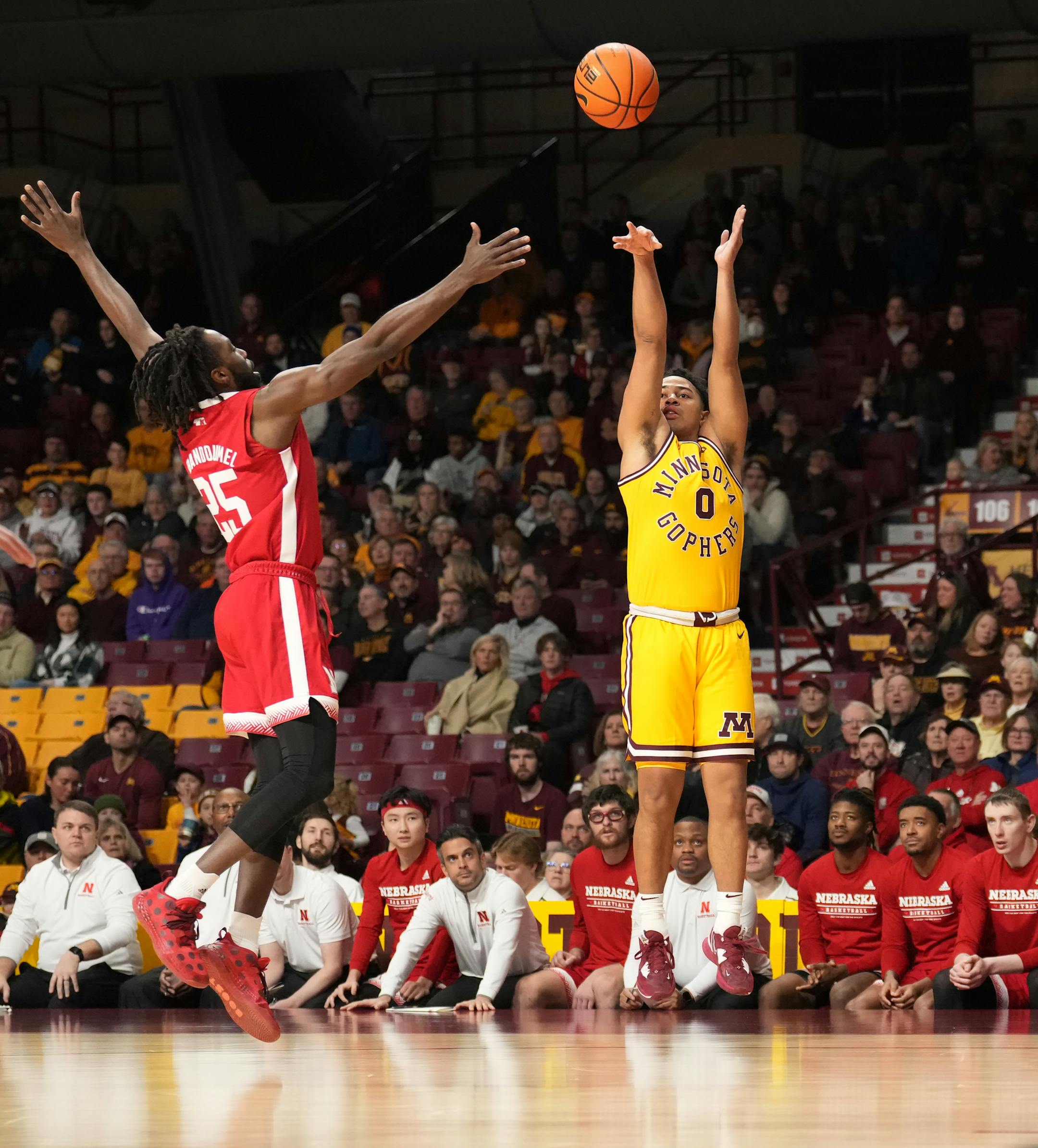Minnesota Golden Gophers guard Taurus Samuels (0) gest a shot up over Nebraska Cornhuskers guard Emmanuel Bandoumel (25) in the first half.