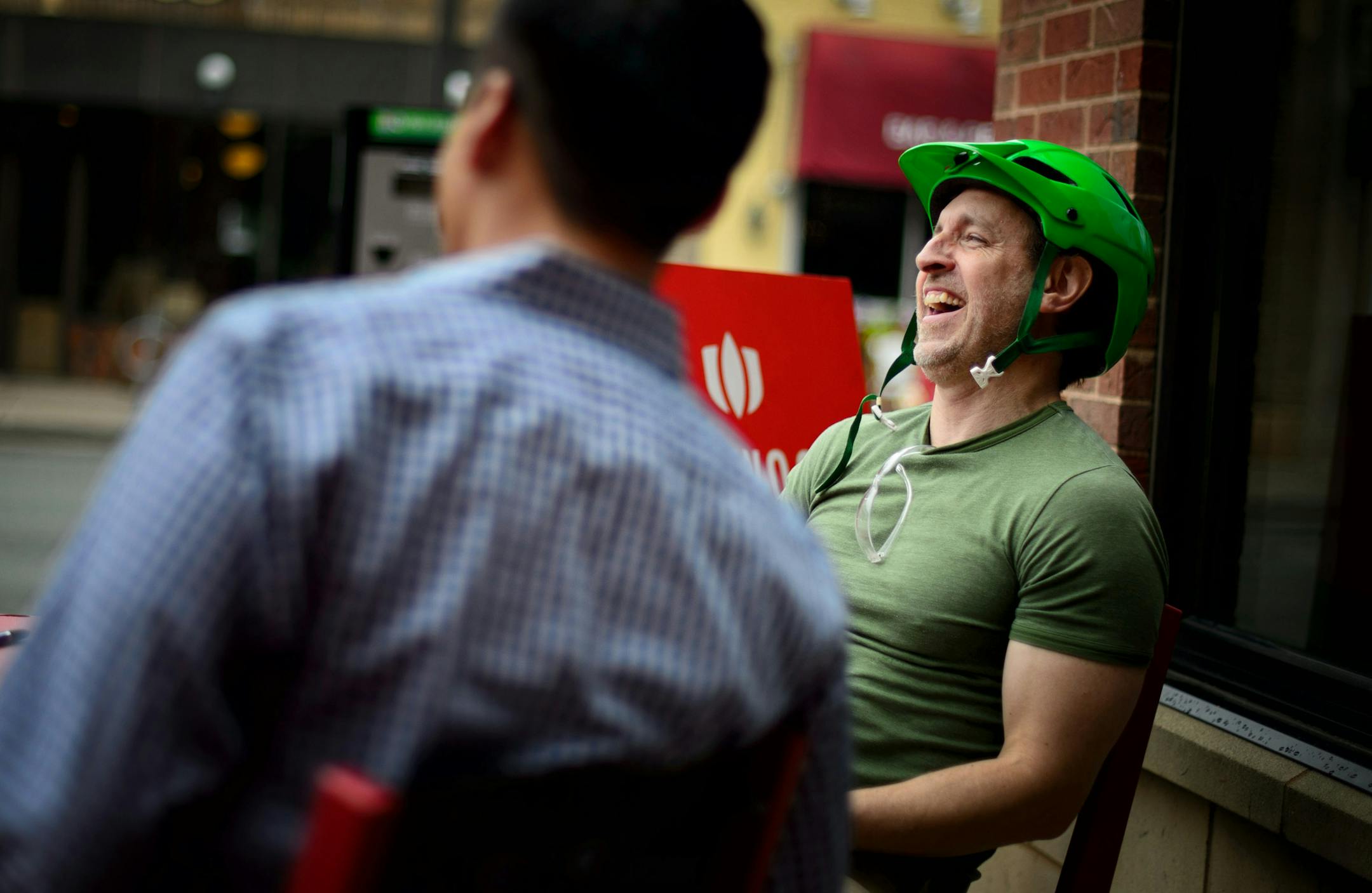 Bruce Cochran, art director of the now defunct Uptown Neighborhood news met with Calhoun Square marketing manager Brian Trinh for MinnyApple.com, a new venture Cochran is working on. ] GLEN STUBBE * gstubbe@startribune.com Thursday, June 4, 2015 EDS: Cochran in green helmet on right