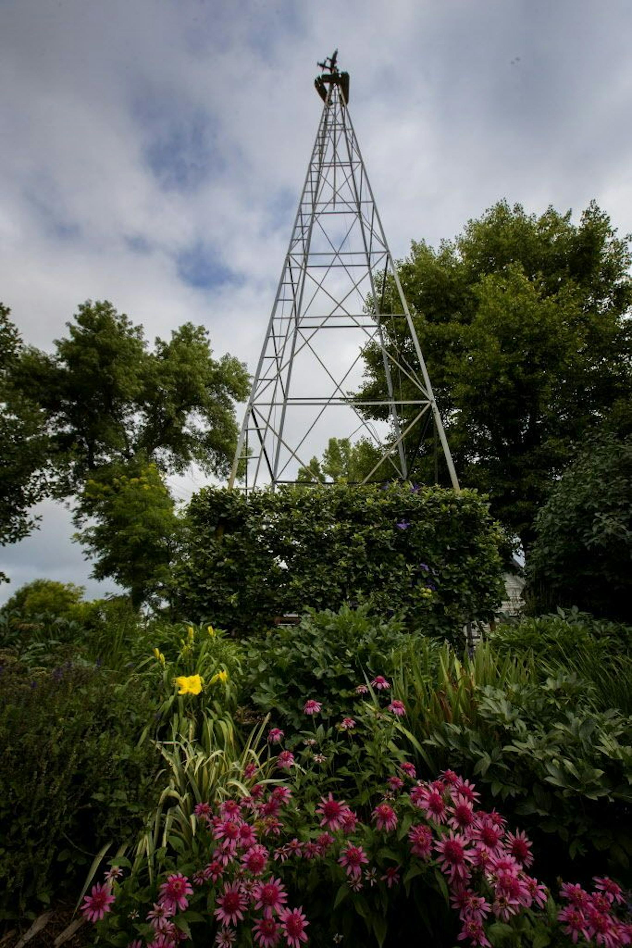 Creative colorful plantings beautify an old windmill.