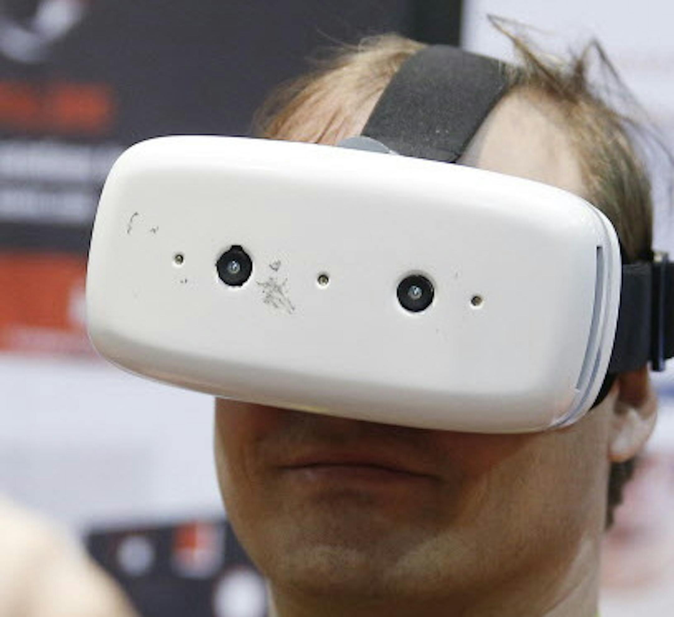 A man demonstrates the uSens Inc. Impression Pi virtual reality and augmented reality interactive device at CES Unveiled, a media preview event for CES International, Monday, Jan. 4, 2016, in Las Vegas. (AP Photo/John Locher)