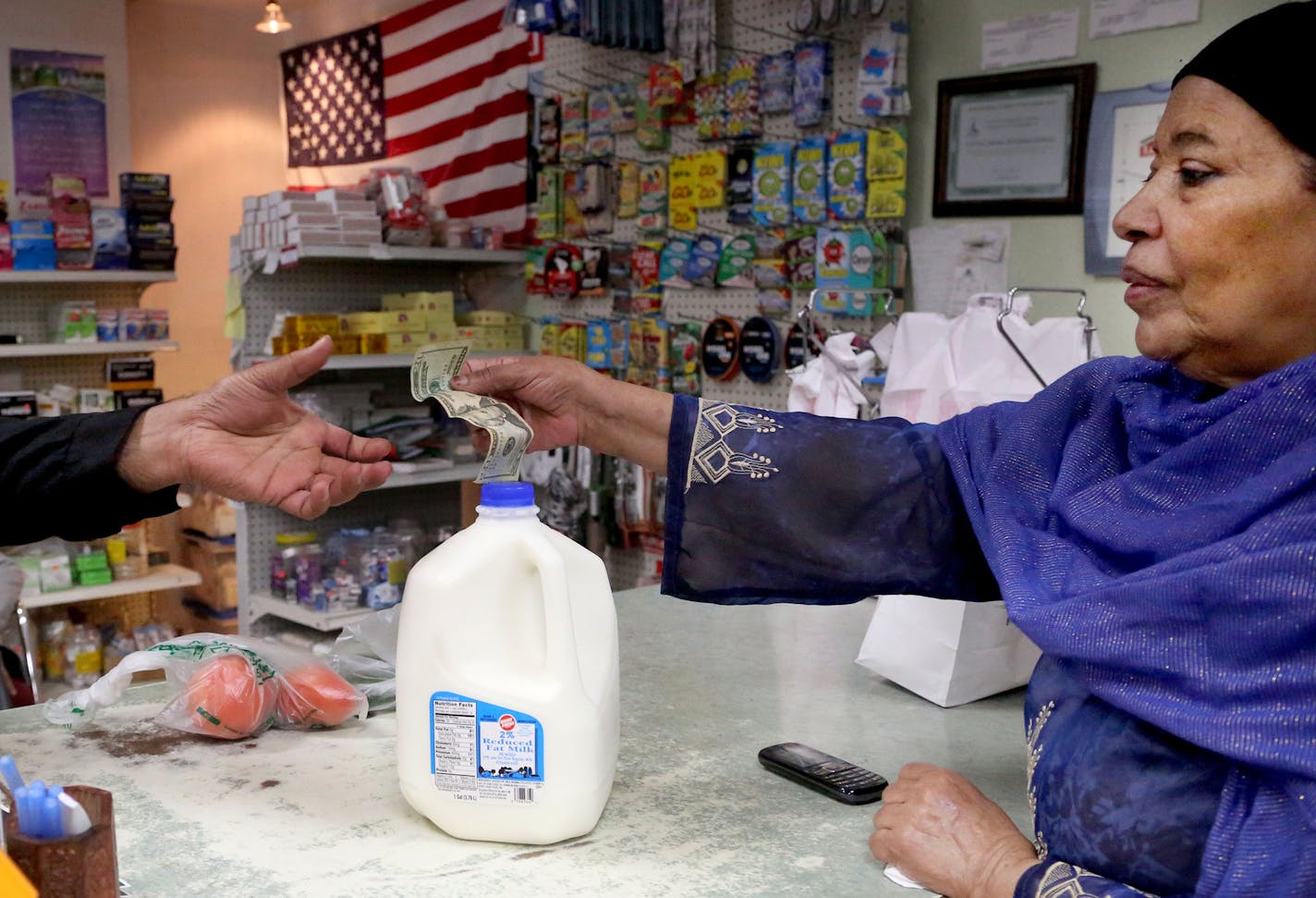 Little India International Market is one of the stores participating in the city's staple food ordinance. Here, store co-owner Faheem Khan waits on Maimuna , right, (that is the only name the woman could come up with) Friday, May 6, 2016, in northeast Minneapolis, MN.](DAVID JOLES/STARTRIBUNE)djoles@startribune.com In April, Minneapolis began enforcing the "Staple Foods" ordinance it passed in 2014, which requires gas stations, corner stores and discount stores that sell food to provide a specif