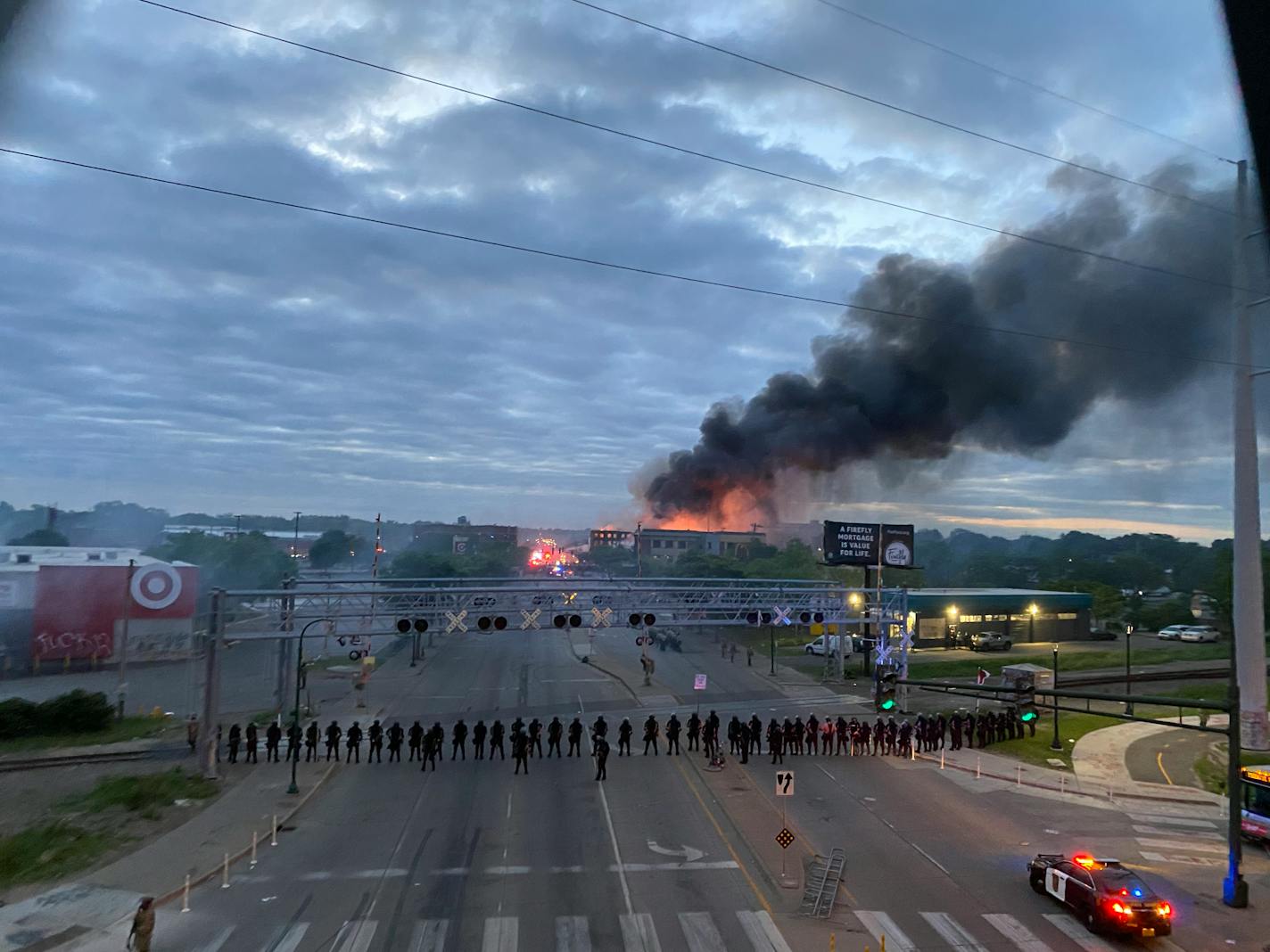 As the sun came up Friday morning over Lake Street in Minneapolis, fires continued to burn in neighborhoods of the Twin Cities.