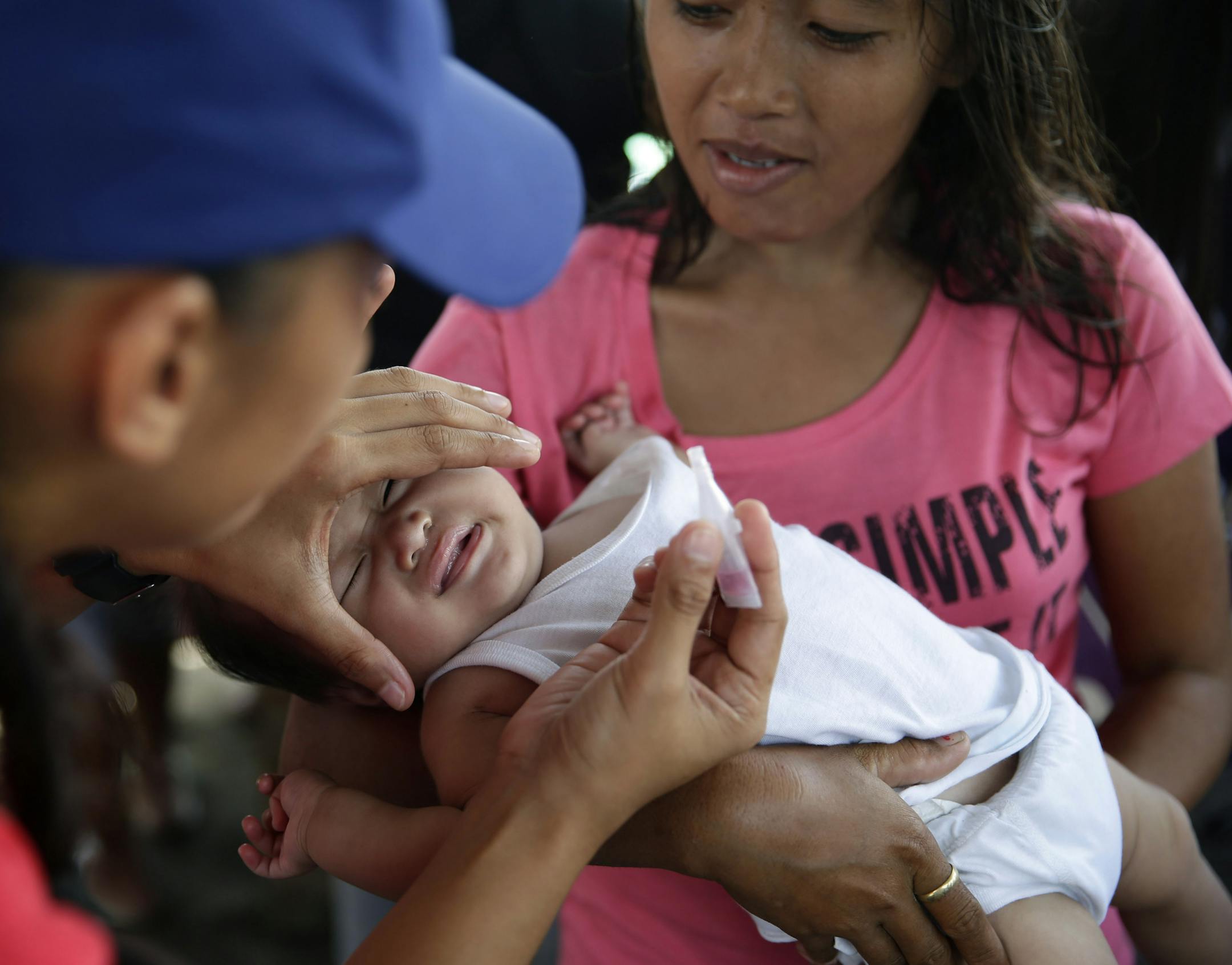 FILE - In this Nov. 26, 2013 file photo, Red Cross and UNICEF medics administer polio and measles vaccinations to children at an evacuation center for typhoon survivors more than two weeks after Typhoon Haiyan ravaged the city of Tacloban, Leyte province in central Philippines. Measles cases in the last five months have caused more U.S. illnesses than in any entire year since 1996, according to numbers released by the Center for Disease control and Prevention on Thursday, May 29, 2014. (AP Photo