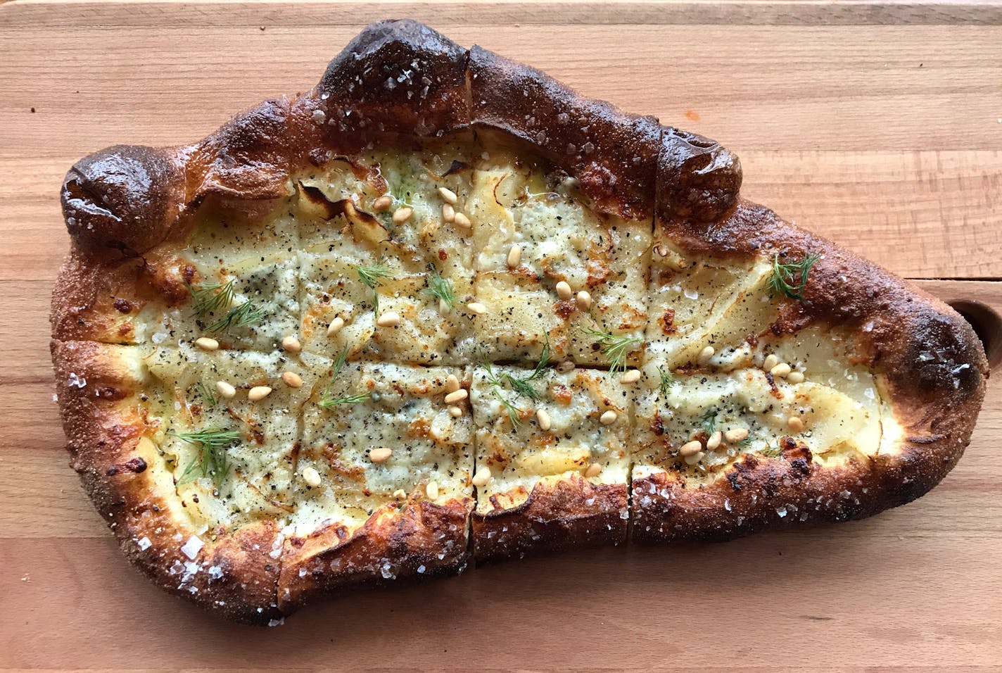 Pearas pizza, with pine nut, pear, dill and Gorgonzola, from Boludo