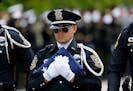 A member of a police honor guard carried a U.S. flag after funeral services for Baton Rouge police officer Matthew Gerald on Friday.