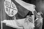 Louise Sundin, who designed the Minneapolis city flag, unfurled the banner with Mayor Eric Hoyer.