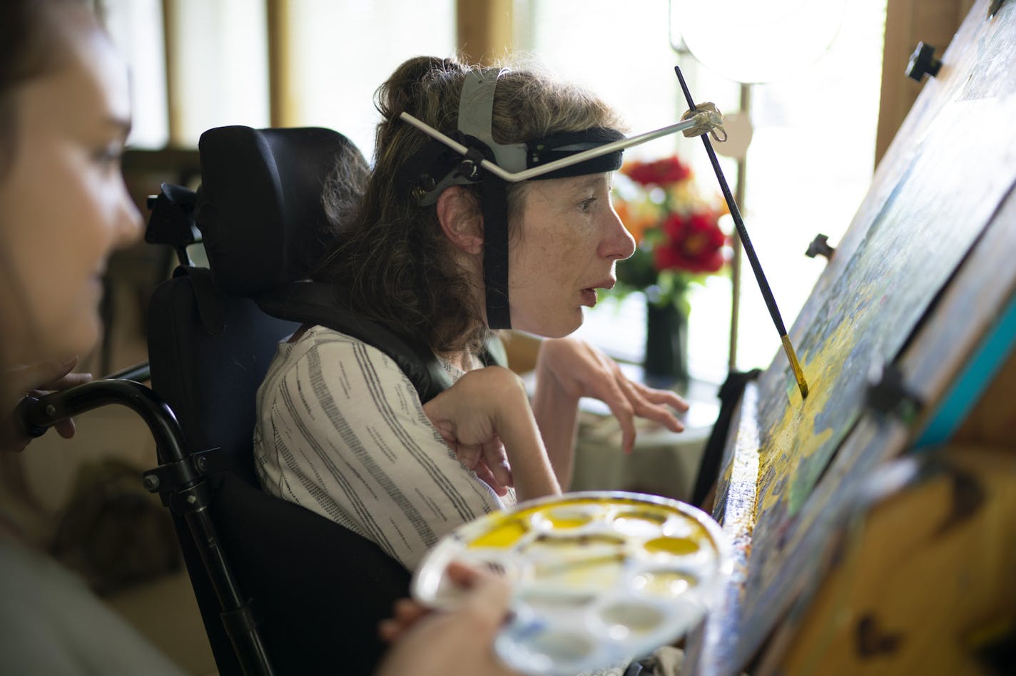 Kari Wagner worked on a painting while her palate was held by Carrie Ingish, a therapeutic recreation specialist with Gillette Children's Specialty Healthcare. ] JEFF WHEELER &#x2022; jeff.wheeler@startribune.com Kari Wagner is an artist who paints despite not having the use of her hands due to her cerebral palsy. She's also non-verbal, though she lives independently with the help of aides in a home with three other women with special needs. She was photographed painting in her studio Thursday a