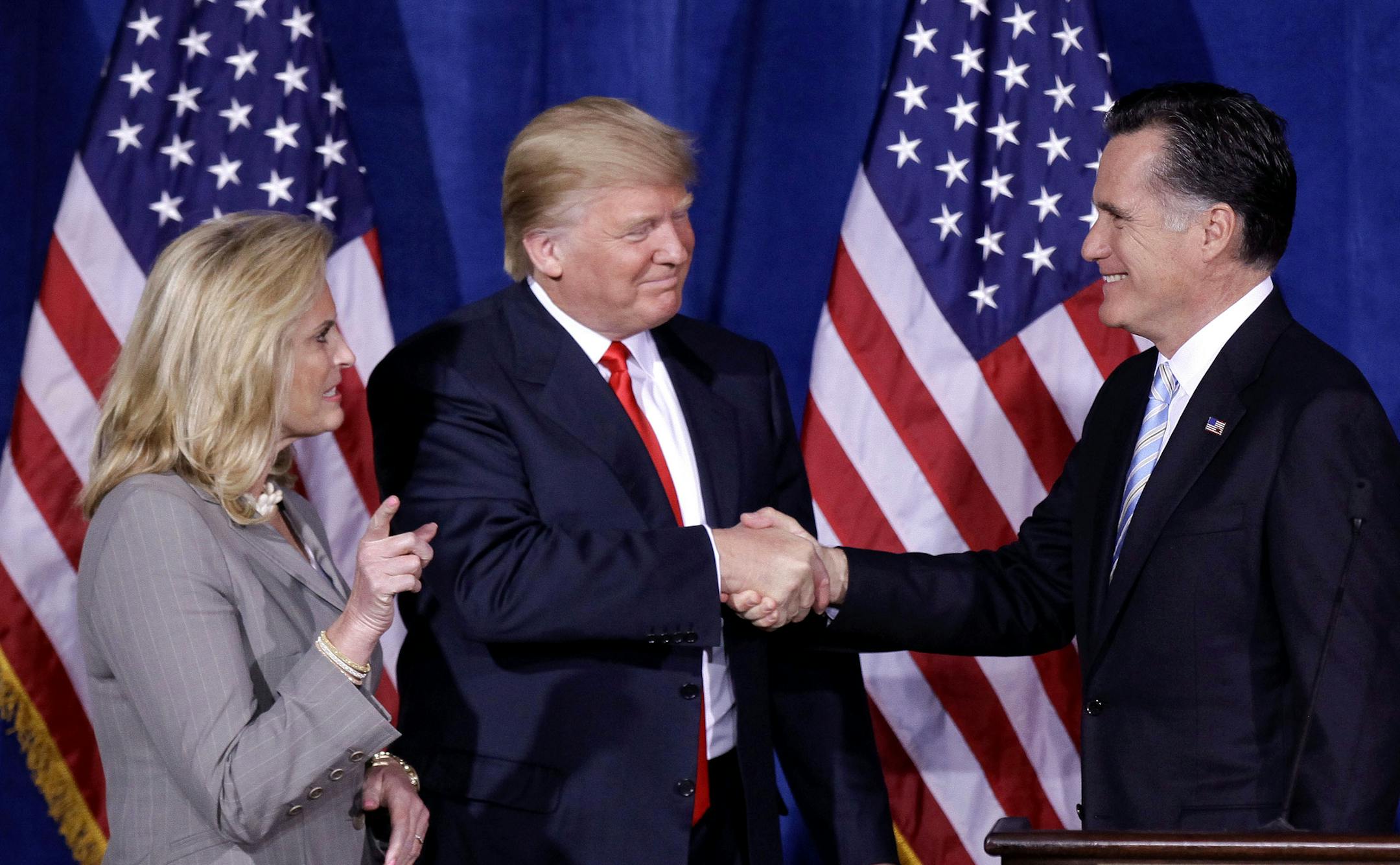 FILE - In this Thursday, Feb. 2, 2012 file photo, Donald Trump greets Republican presidential candidate, former Massachusetts Gov. Mitt Romney, after announcing his endorsement of Romney during a news conference in Las Vegas. Trump is endorsing Romney in Utah's Senate race, another sign that the two Republicans are burying the hatchet after a fraught relationship. (AP Photo/Julie Jacobson, File)