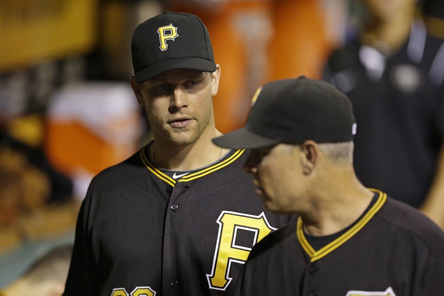 Pittsburgh Pirates' Justin Morneau, left, talks with Pirates hitting coach Jay Bell in the dugout during a baseball game against the St. Louis Cardinals in Pittsburgh Saturday, Aug. 31, 2013. Morneau was acquired from the Minnesota Twins.