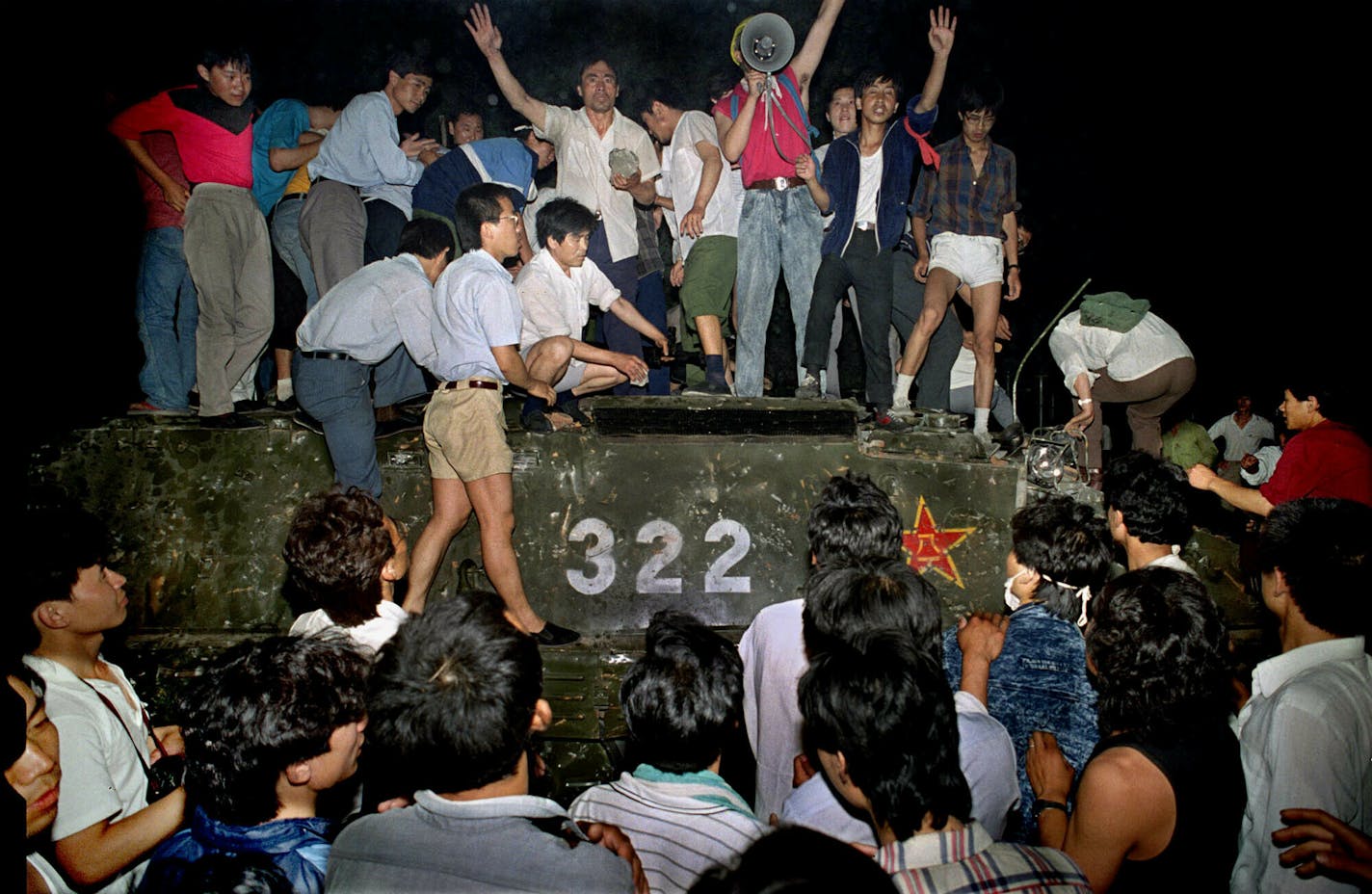 FILE - In this early June 4, 1989, file photo, civilians hold rocks as they stand on a government armored vehicle near Changan Boulevard in Beijing. Over seven weeks in 1989, student-led pro-democracy protests centered on Beijing&#x2019;s Tiananmen Square became China&#x2019;s greatest political upheaval since the end of the Cultural Revolution more than a decade earlier. (AP Photo/Jeff Widener, File)