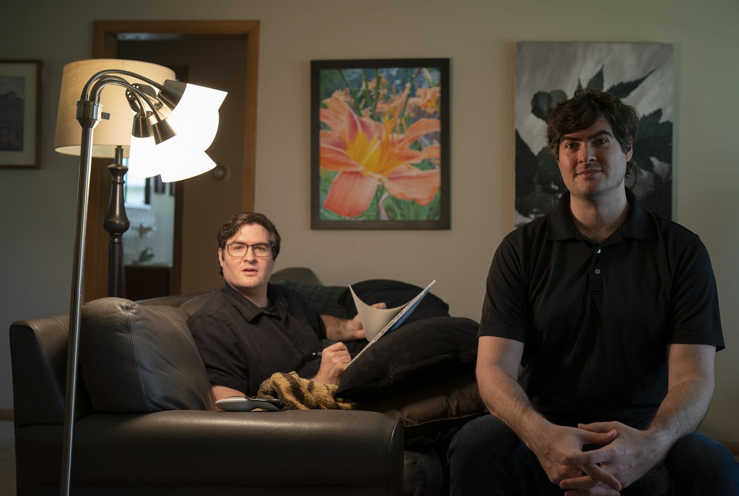 Rowan, left, and Bly Pope in the living room of the St. Paul duplex where they live and work. Rowan usually works in the liviing room. Two of Bly's paintings are on the wall behind them. ] JEFF WHEELER &#x2022; jeff.wheeler@startribune.com Bly and Rowan Pope are fraternal twins and virtuosic artists from a creative lineage (poet Freya Manfred, who wrote a memoir about raising them & screenwriter Tom Pope) who launched onto the scene with a show of their photorealistic drawings at Mia last year.