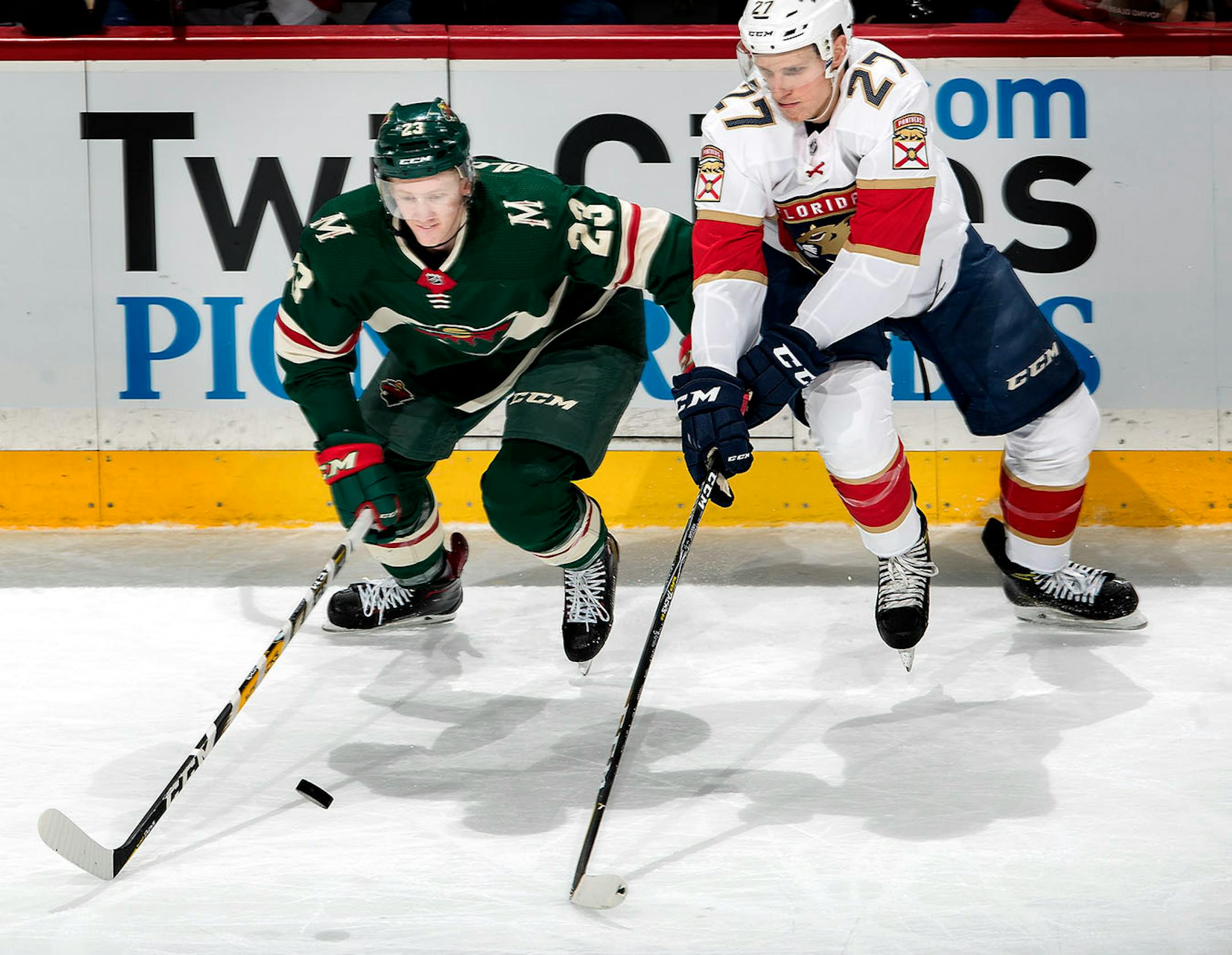 Gustav Olofsson (23) and Nick Bjugstad (27) fought for the puck in the second period.