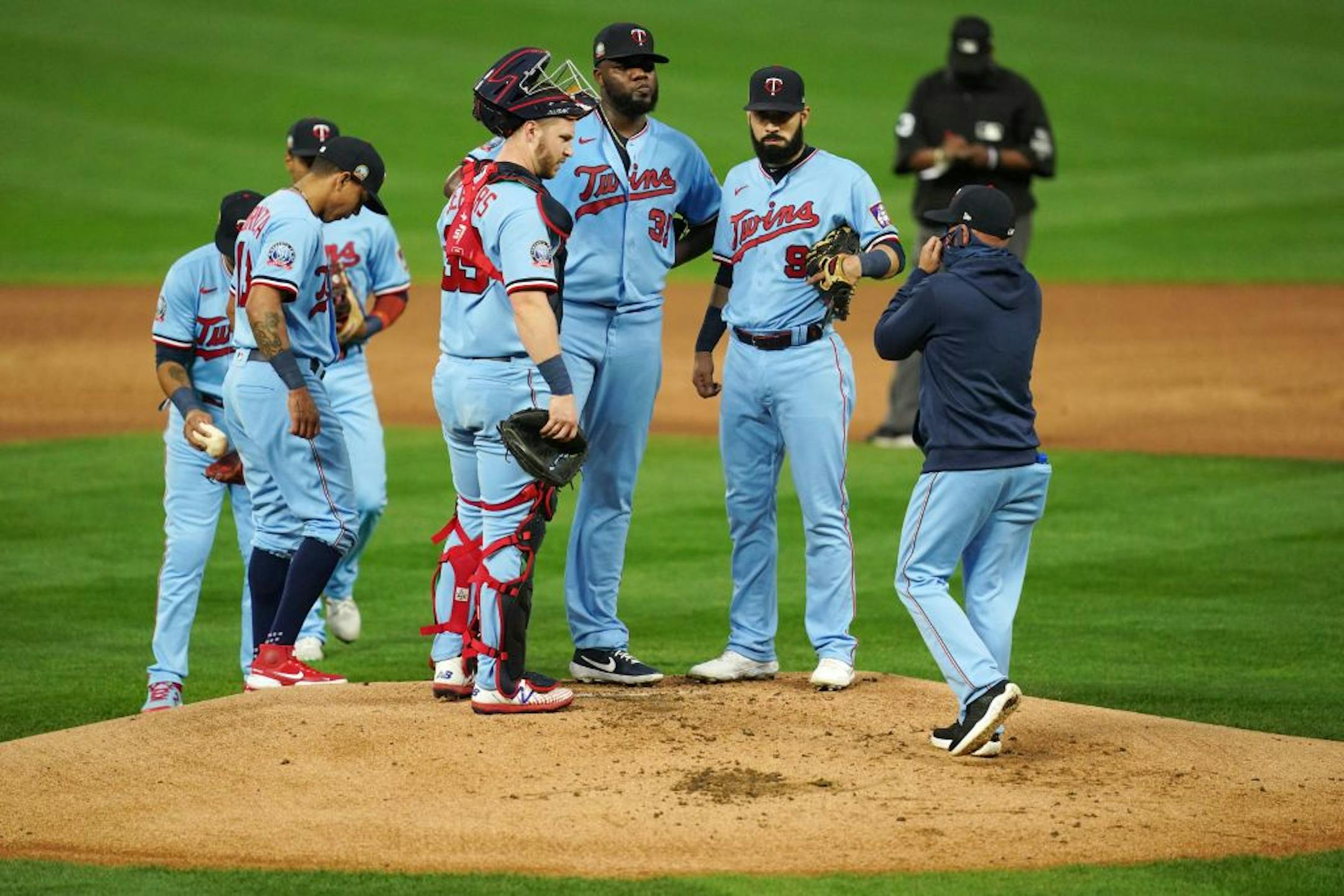 Minnesota Twins starting pitcher Michael Pineda (35) got a visit on the mound from pitching coach Wes Johnson (47) after giving up a run in the first inning.