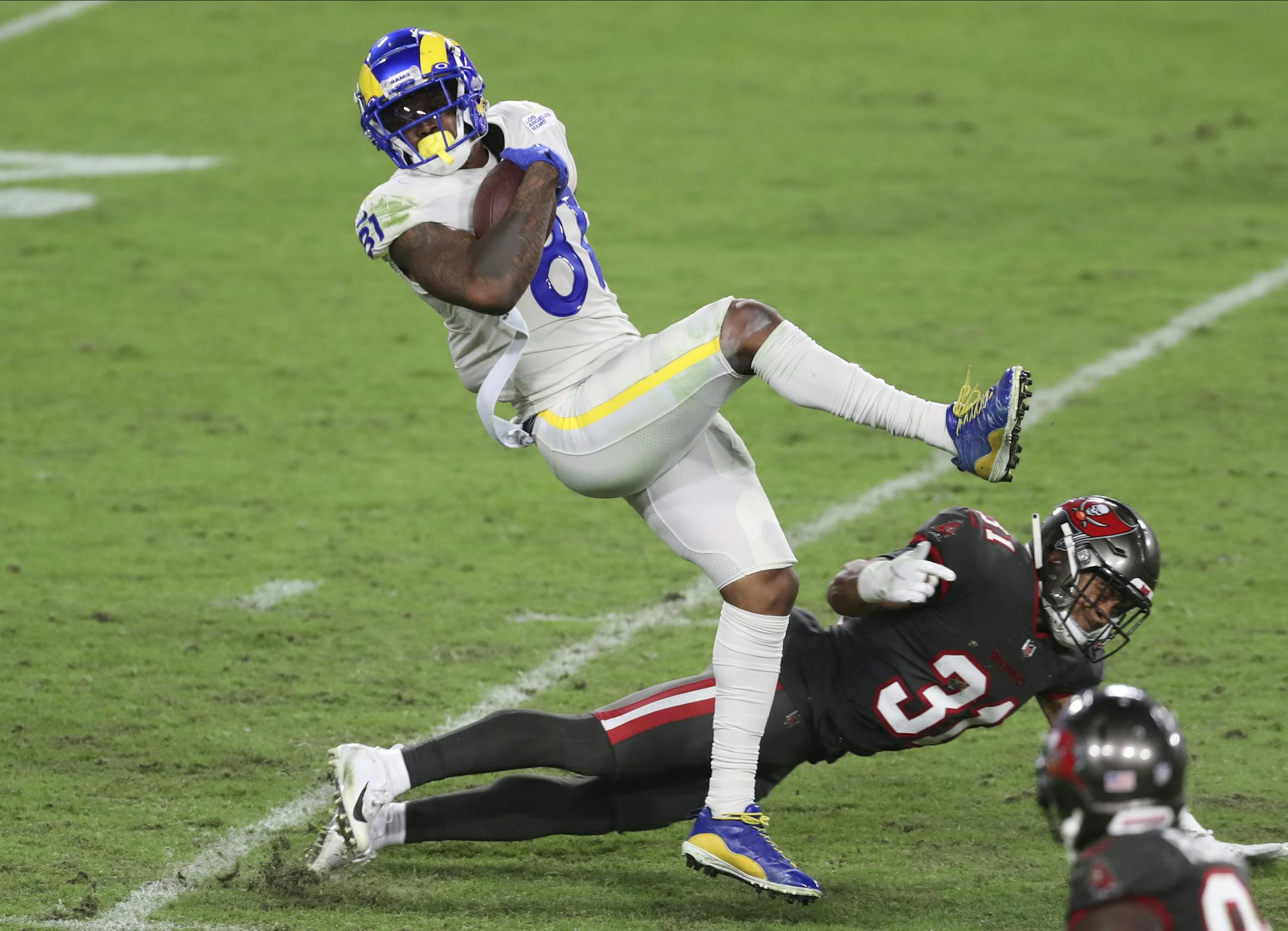 Los Angeles Rams tight end Gerald Everett (81) gets hit by Tampa Bay Buccaneers strong safety Antoine Winfield Jr. (31) during the second half of an NFL football game Monday, Nov. 23, 2020, in Tampa, Fla. (AP Photo/Mark LoMoglio)