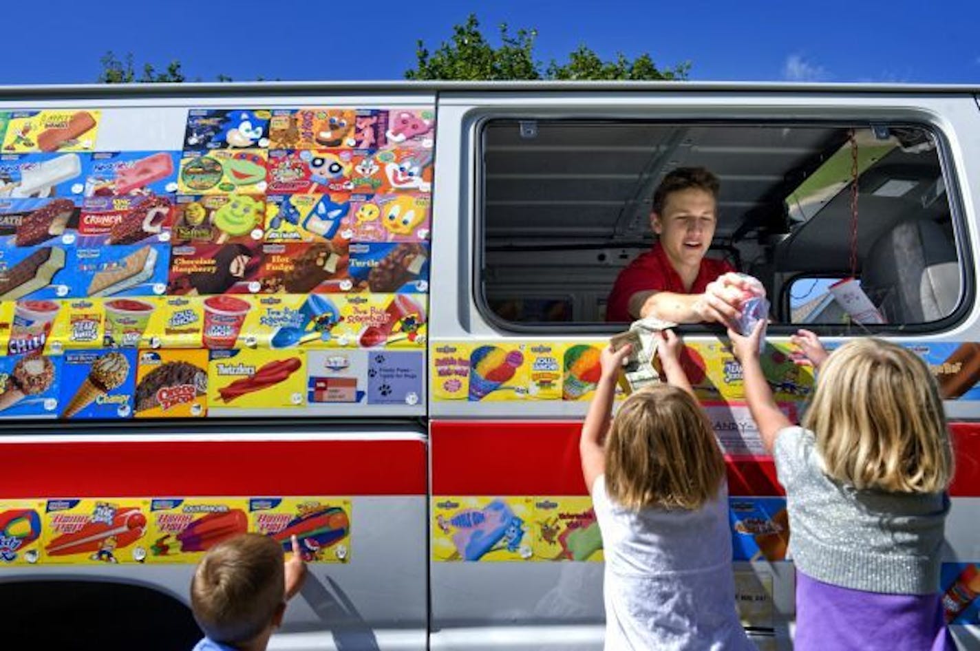 Mik Bushinski sold snow cones from his truck to Ava Ehmke and Katie Costello, both 5, on a Woodbury culdesac near his home.