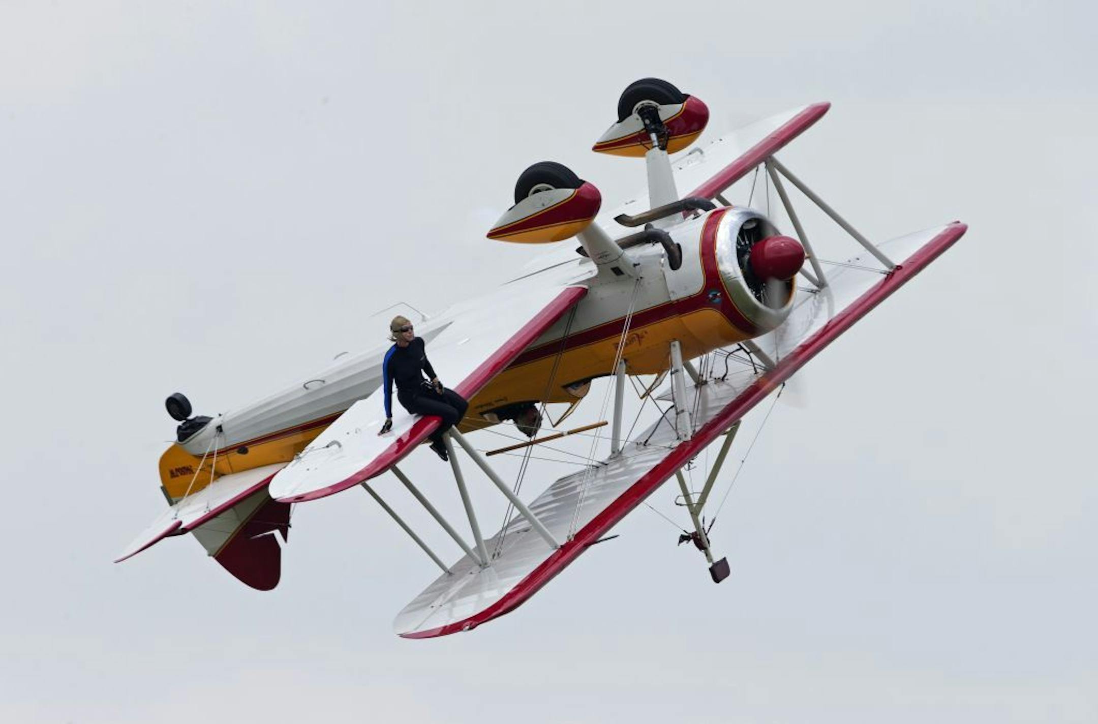 A wing walker performs at the Vectren Air Show just before crashing, Saturday, June 22, 2013, in Dayton, Ohio. The crash killed the pilot and the stunt walker instantly, authorities said.