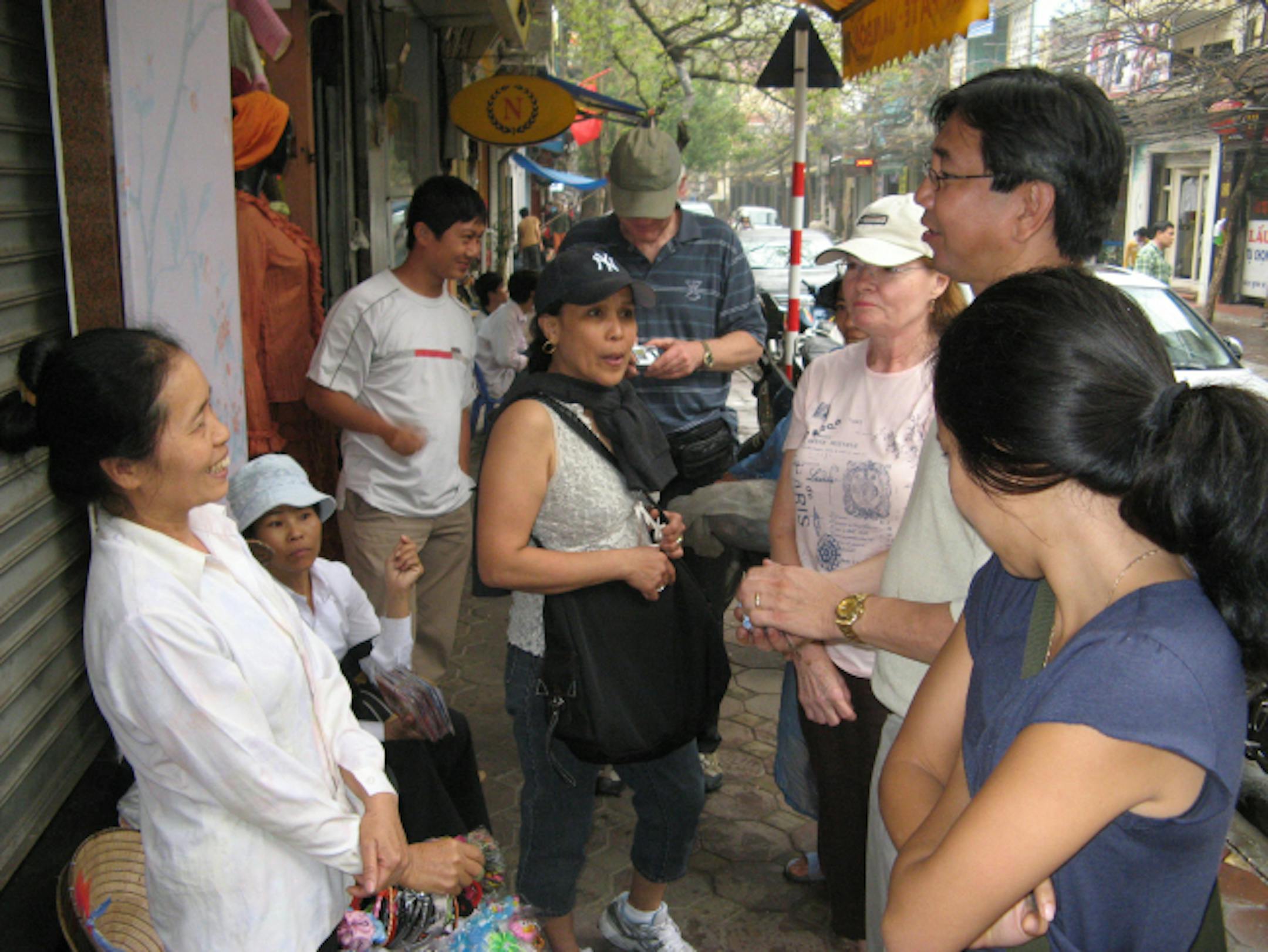A Hanoi shopkeeper surrounded by Minnesotans. From left: Anita Smallwood, Joan Carlson, Paul Smallwood and Marianne Smallwood.