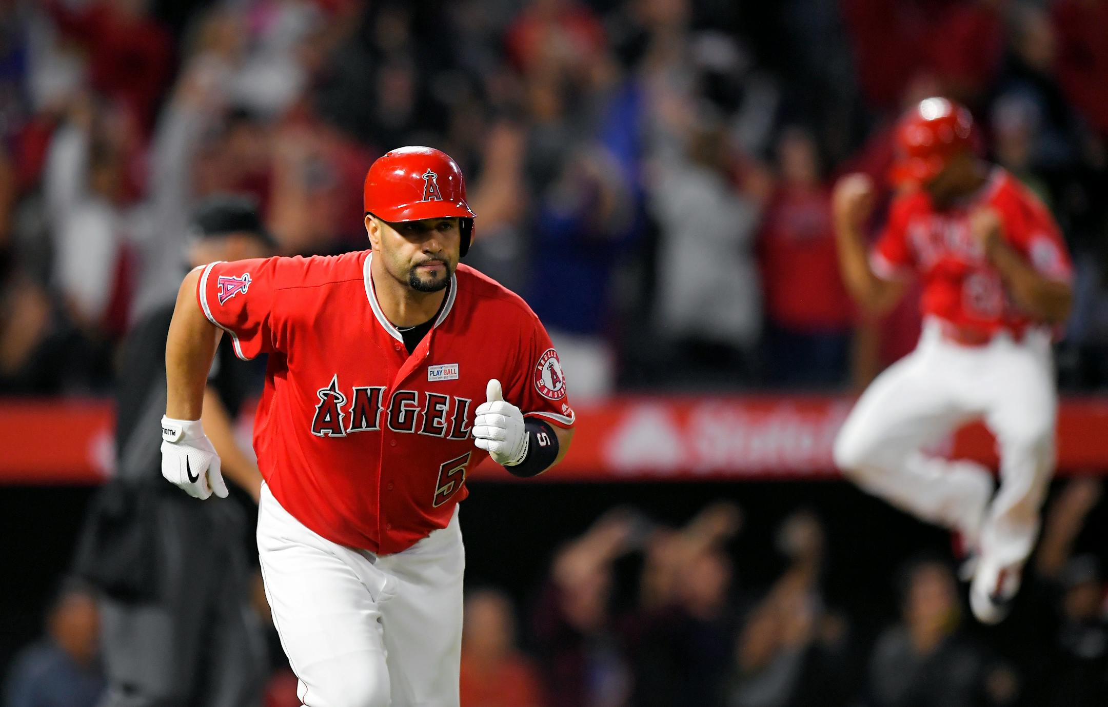 Angels teammate Ben Revere, right, jumped for joy when Albert Pujols hit is 600th home run Saturday night, but the milestone didn't come with the fanfare it would have decades ago.