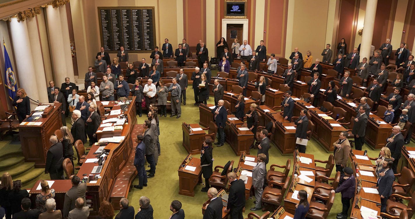 Minnesota State House representatives stood for the Pledge of Allegiance at the start of the legislative session Tuesday, Feb. 11, 2020 at the State Capitol in St. Paul, Minn. (Anthony Souffle/Star Tribune via AP)