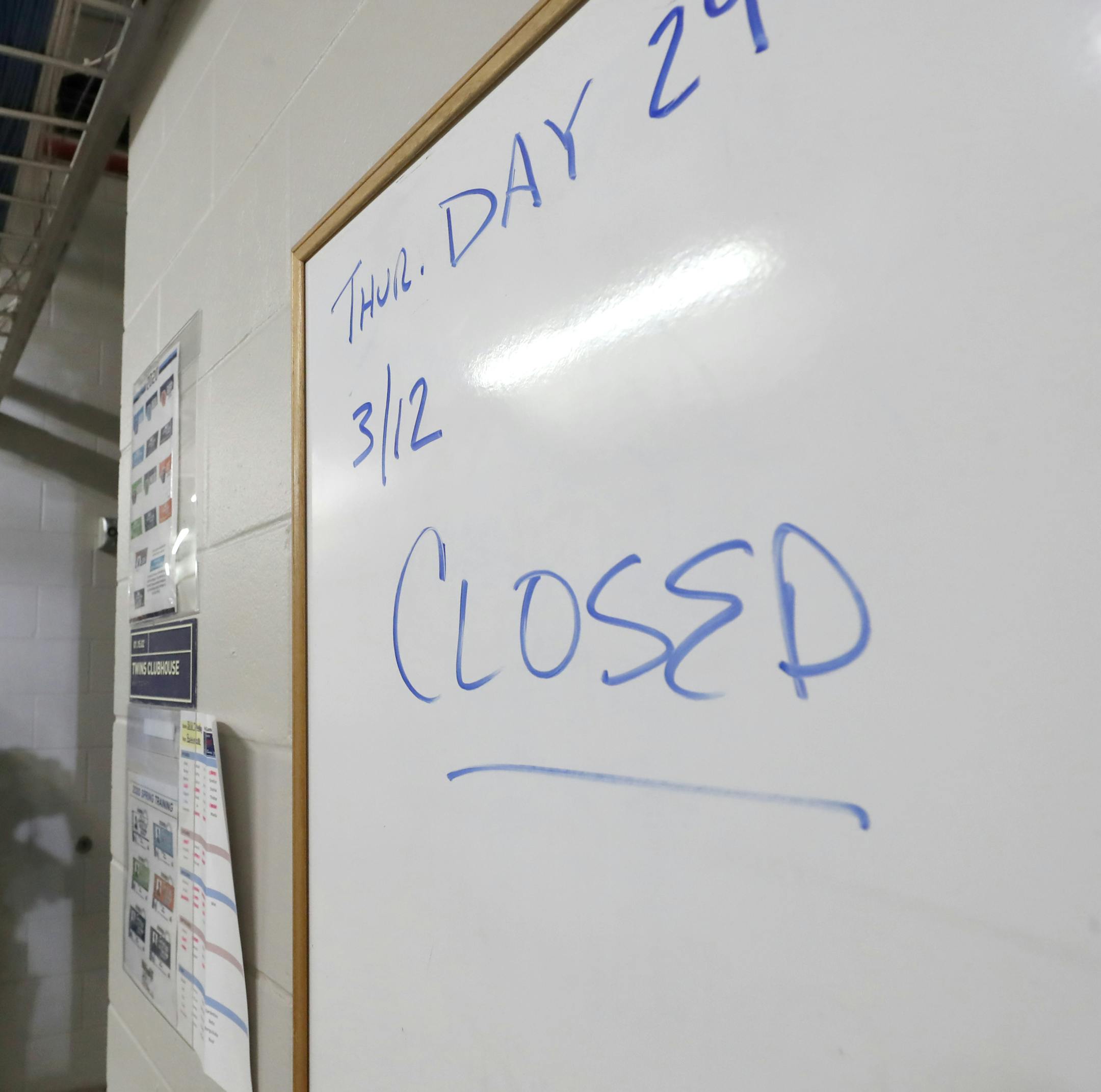Hammond Stadium worker Paul Francis stands outside the Minnesota Twins' clubhouse after a game between the Twins and the Baltimore Orioles was canceled Thursday, March 12, 2020, in Fort Myers, Fla. Major League Baseball has suspended the rest of its spring training game schedule because of the coronavirus outbreak. MLB is also delaying the start of its regular season by at least two weeks. (AP Photo/Elise Amendola)