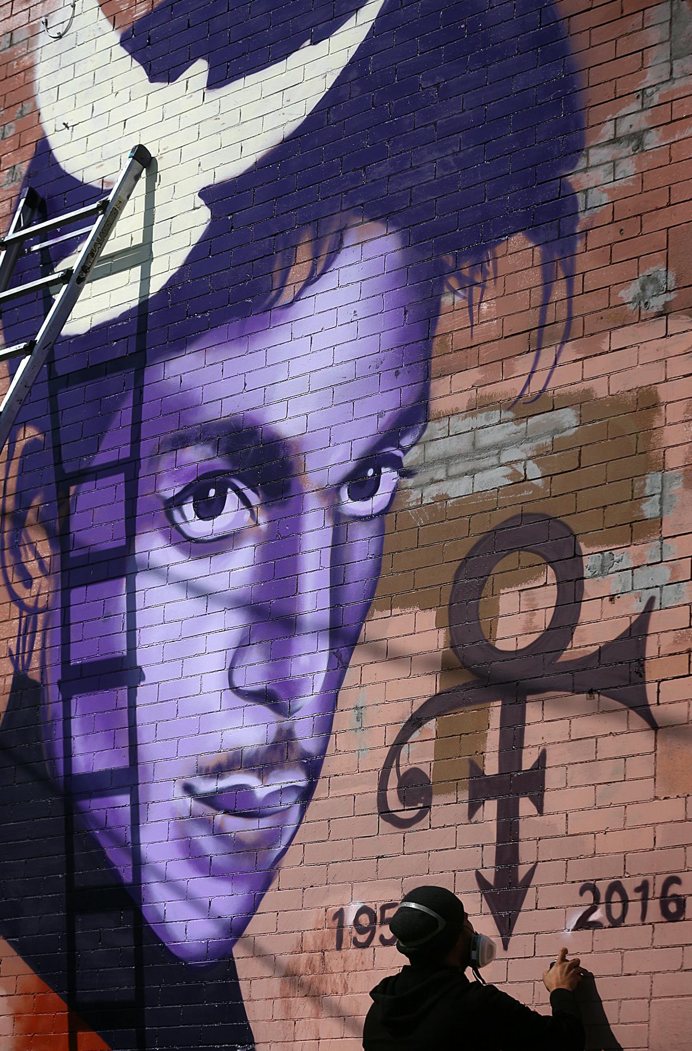 Artist Rock Martinez, 35, Minneapolis, worked on a mural he is painting to honor Prince at 26th Street and Hennepin Avenue.