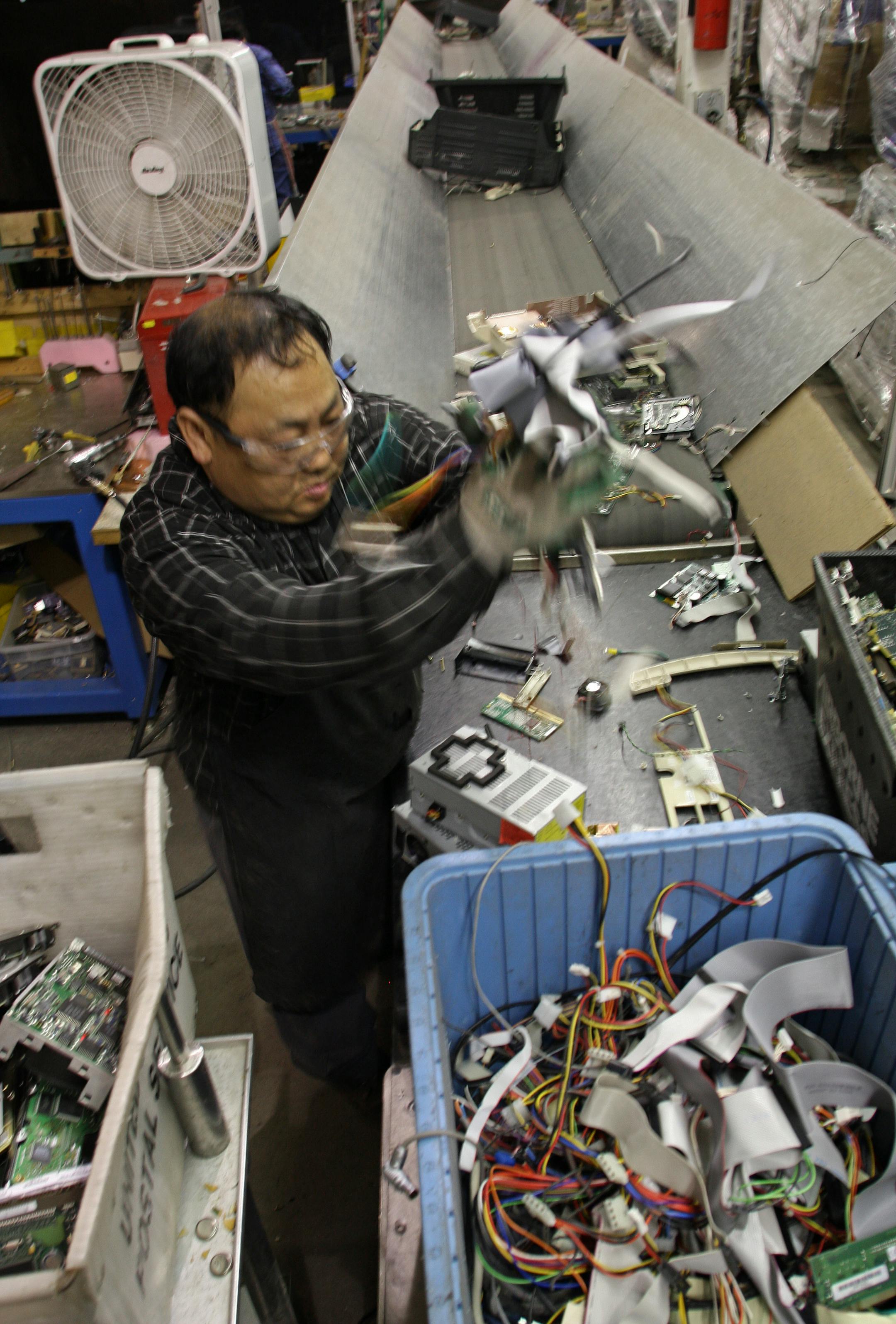 Pen Cher Vang sorted various parts of tube televisions, computers and computer monitors as they came down a disassembly line at Materials Processing Corporation in Eagan. The facility was still working on recycling all the electronics that were dropped off at the Mall of America this fall.