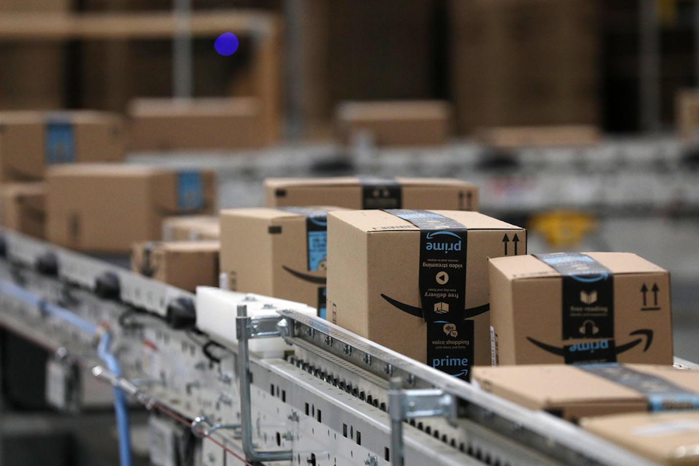 Packages passed down a conveyor belt before receiving a shipping label at Amazon in Shakopee.